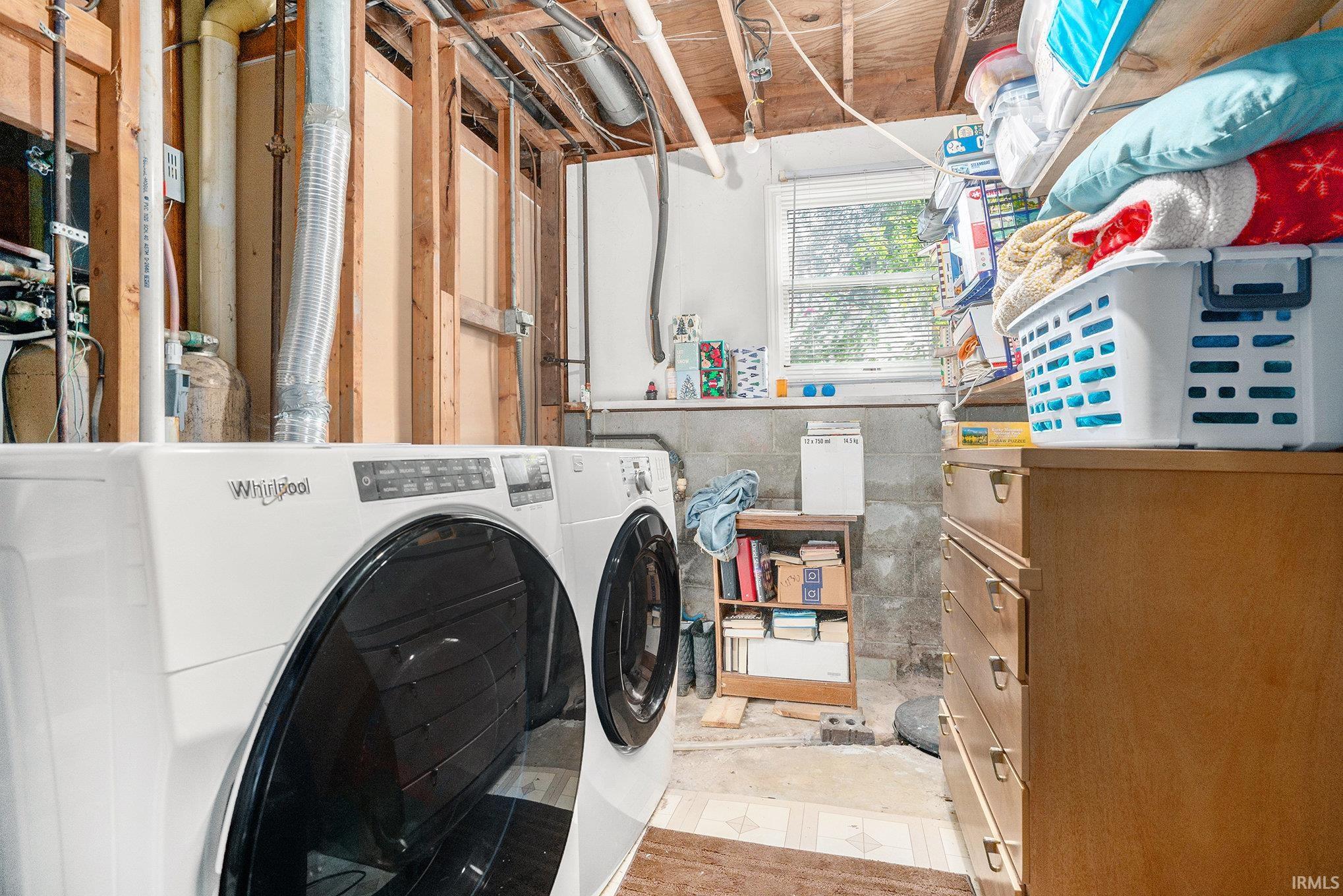 Laundry area featuring separate washer and dryer and light flooring
