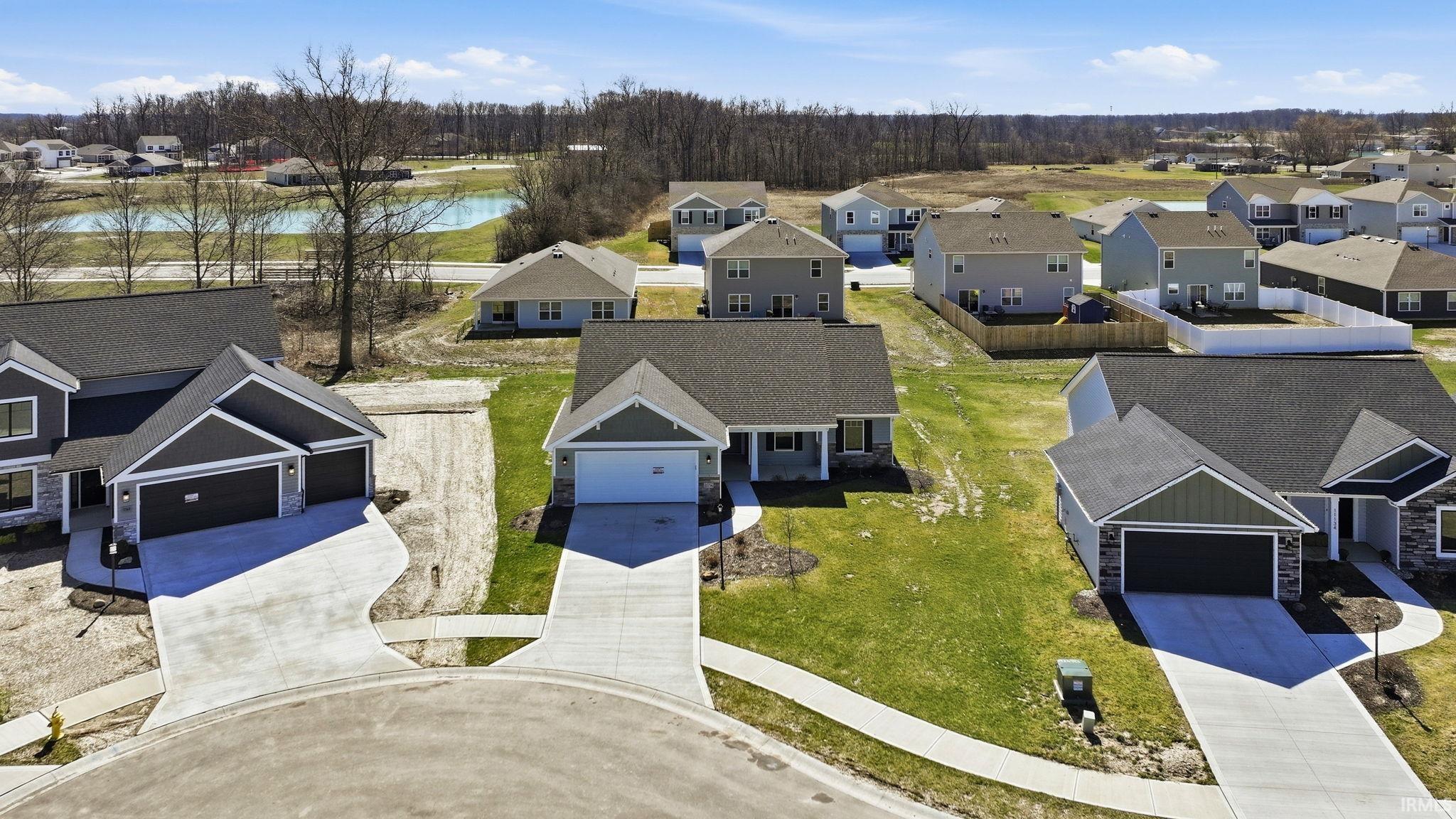 Aerial perspective of suburban area with a nearby body of water