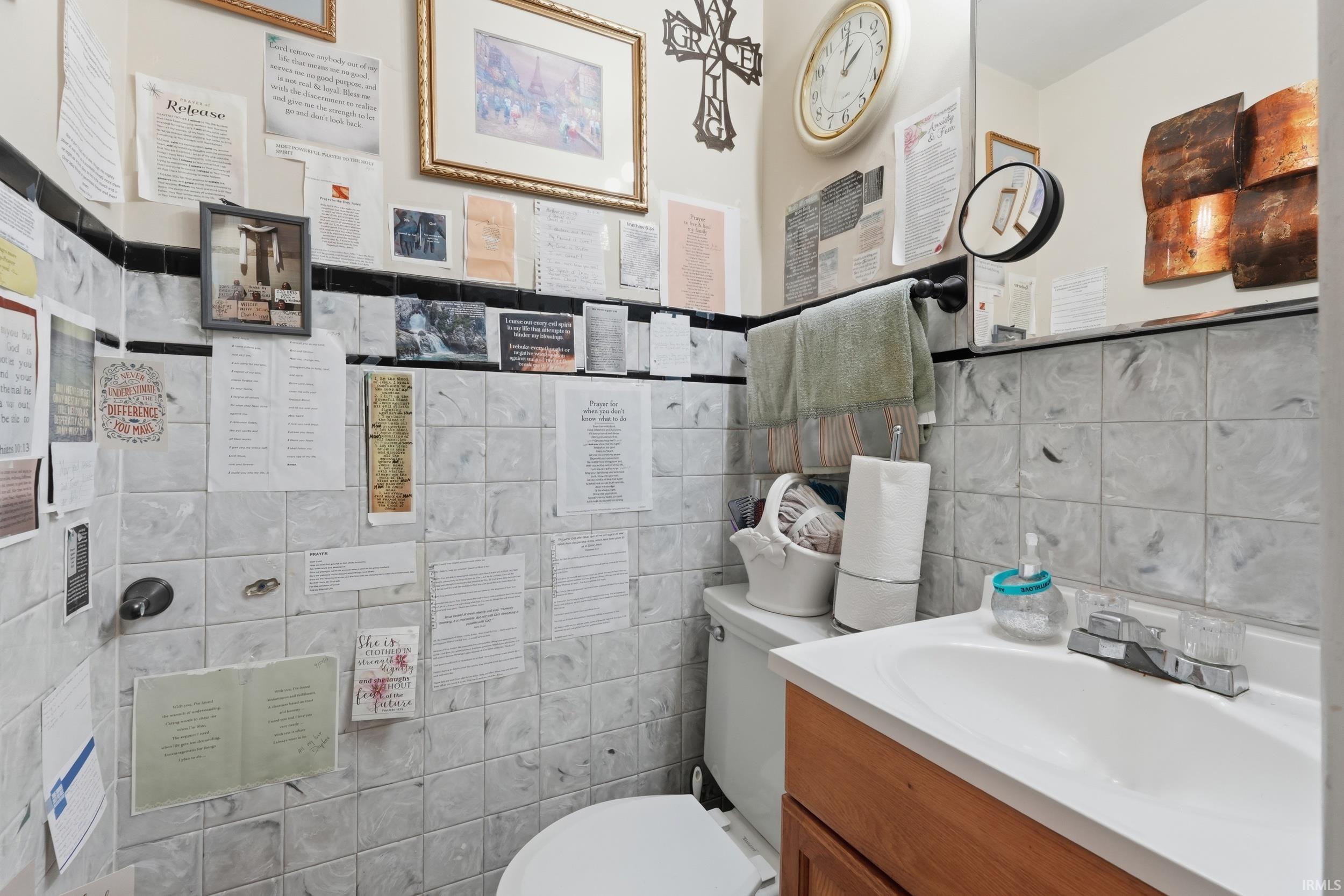 Bathroom featuring vanity and tile walls