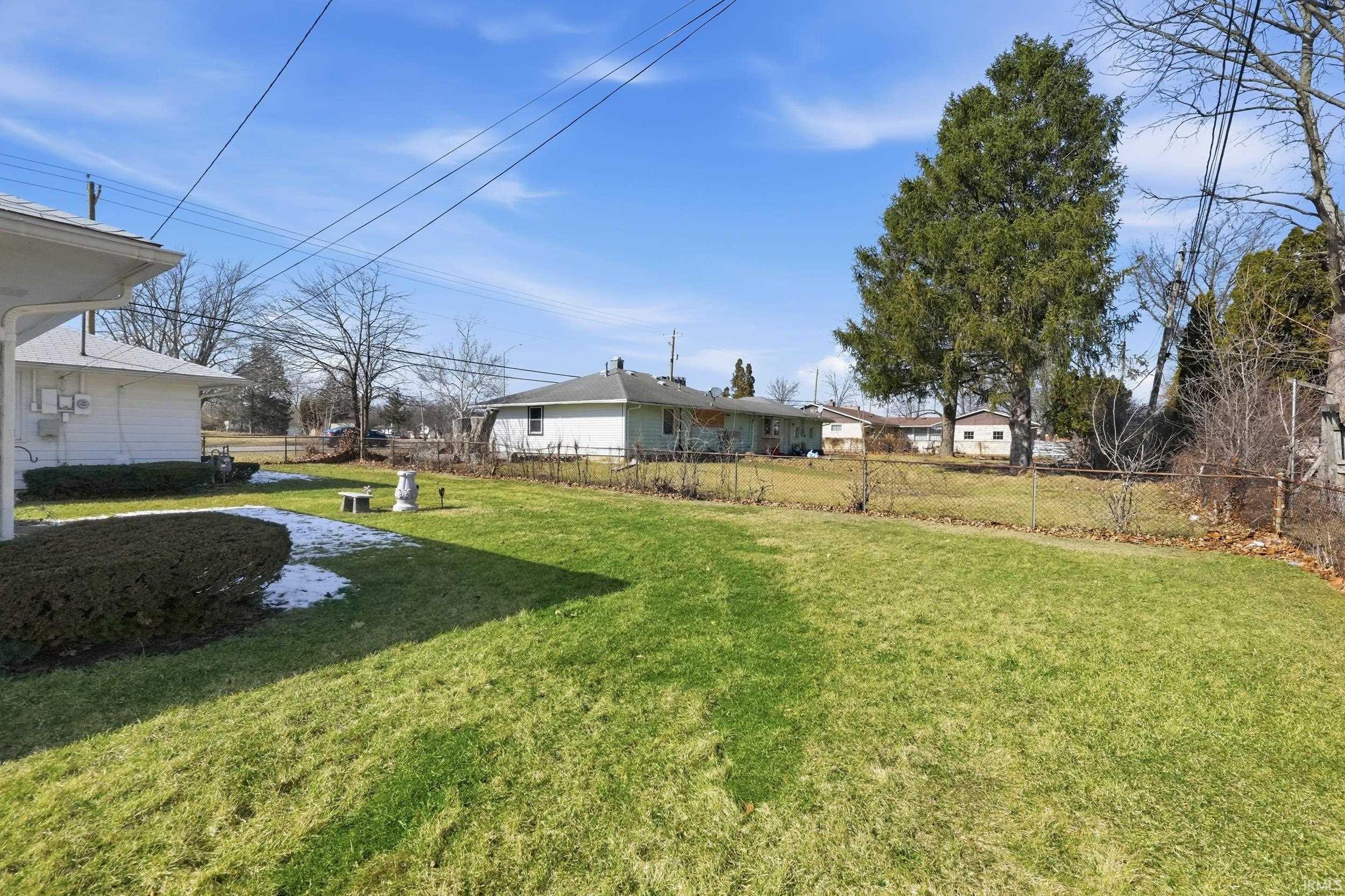 Fenced backyard with a residential view