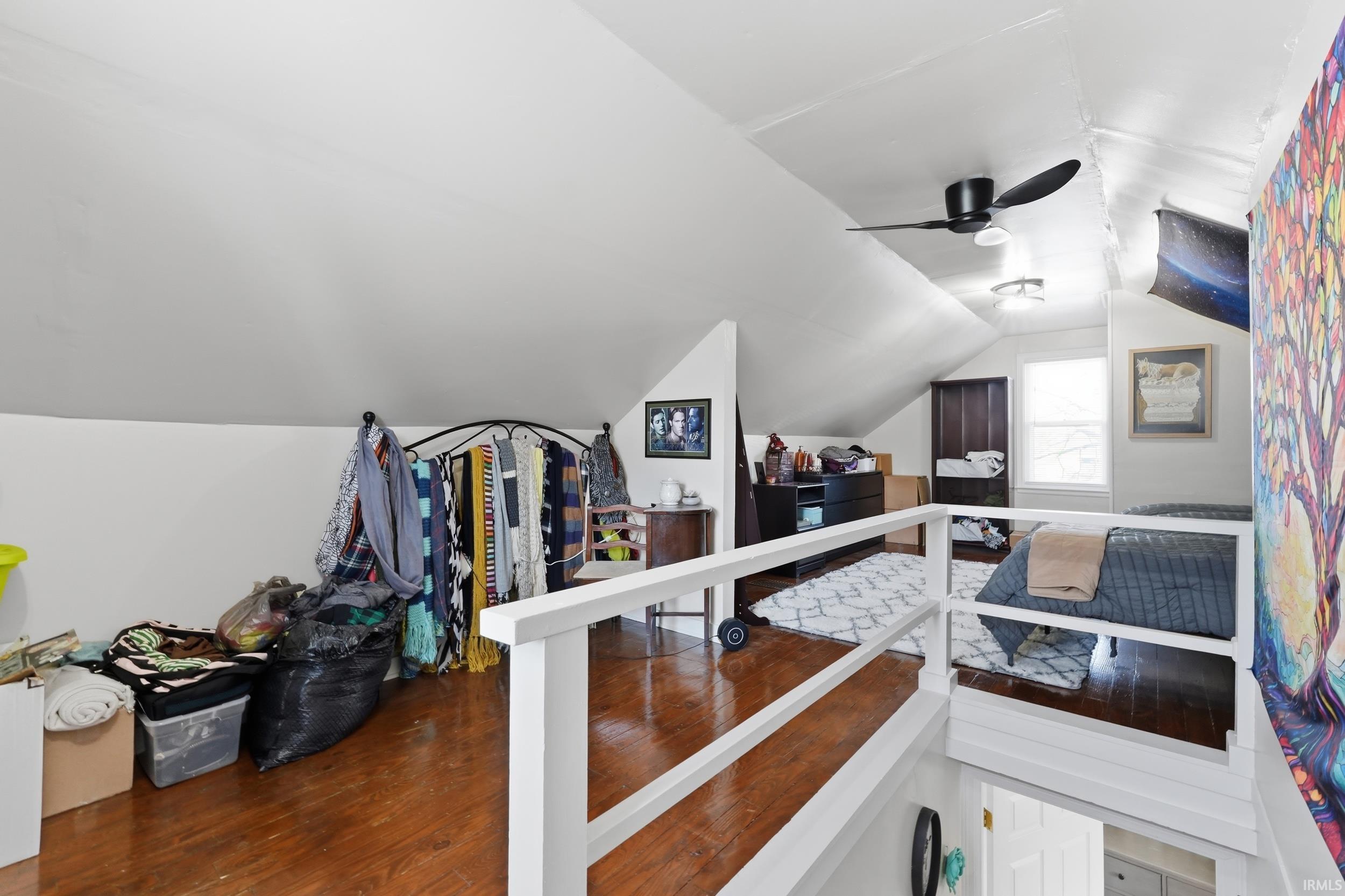 Bedroom with wood finished floors and a ceiling fan