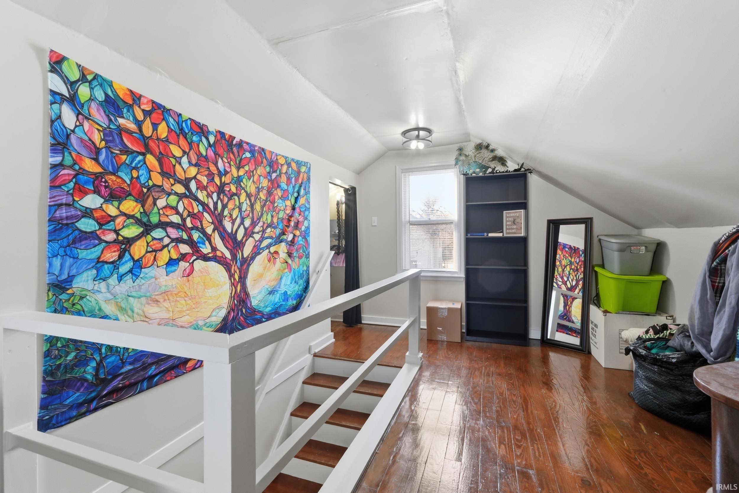 Bonus room with dark wood-style floors