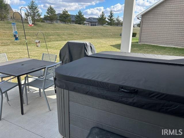 View of patio / terrace with outdoor dining space and a hot tub