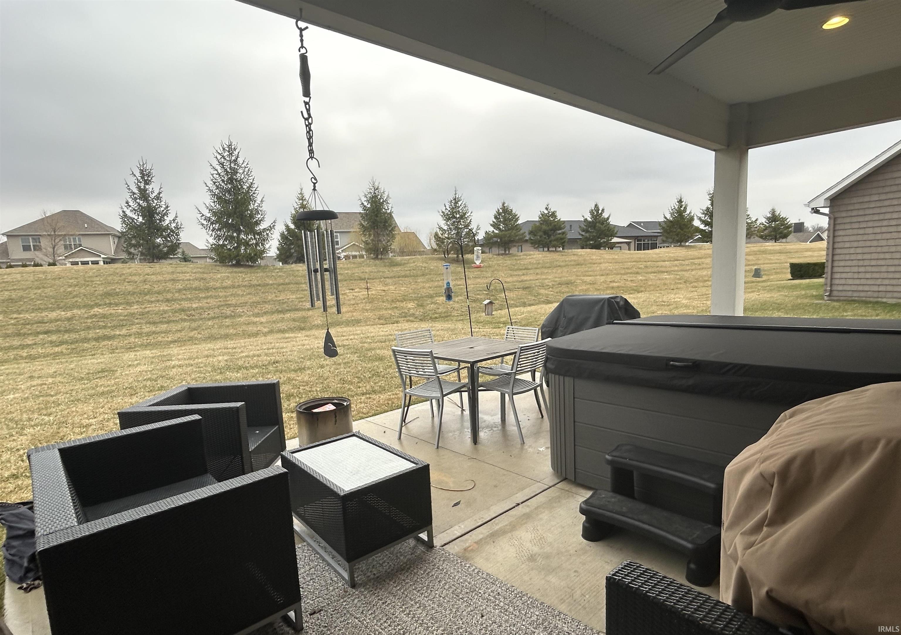 View of patio featuring a hot tub and ceiling fan