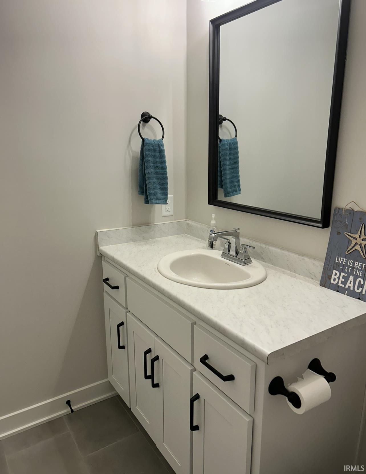Bathroom featuring vanity and dark tile patterned flooring