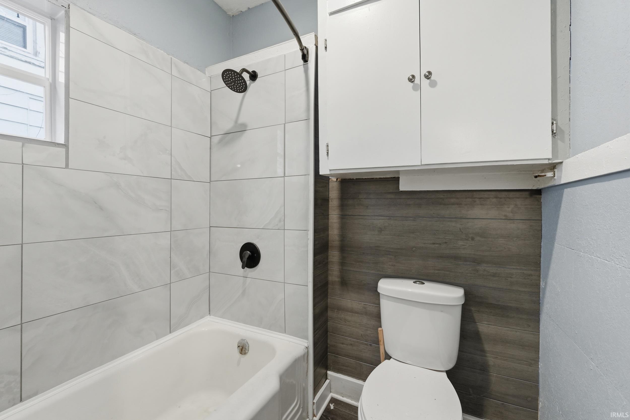 Full bathroom with toilet and shower / bathtub combination