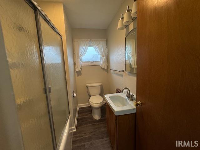 Full bathroom featuring vanity and dark wood-style flooring