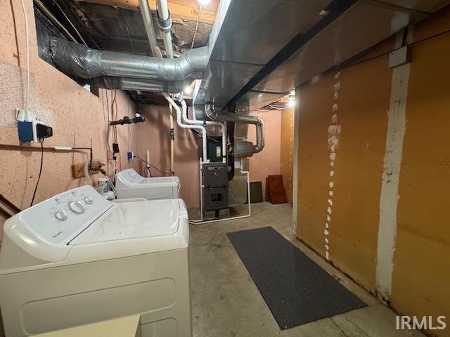 Unfinished basement featuring washing machine and dryer