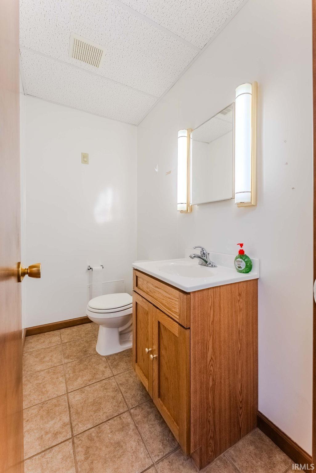 Bathroom with vanity and light tile patterned flooring