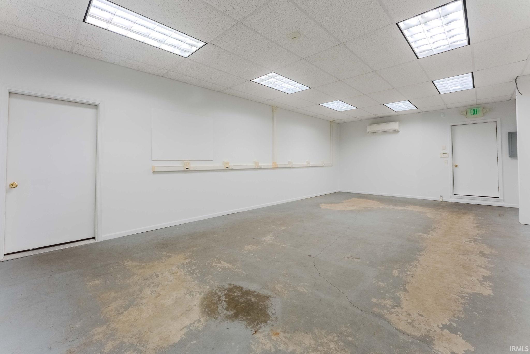 Miscellaneous room with a paneled ceiling and a wall mounted mini split