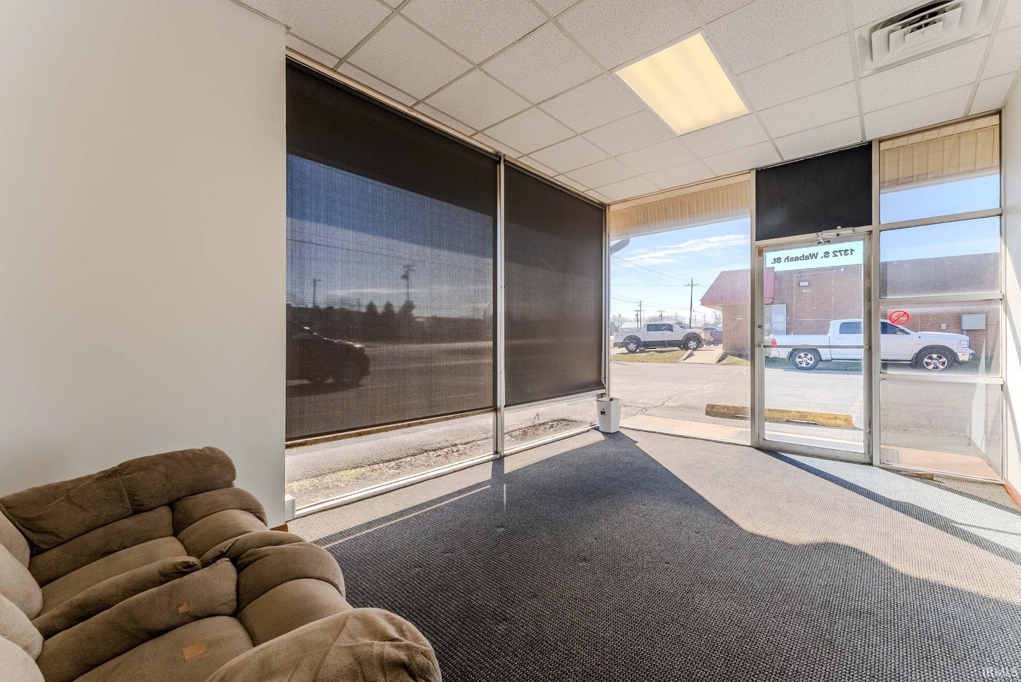 Building lobby featuring floor to ceiling windows and a drop ceiling