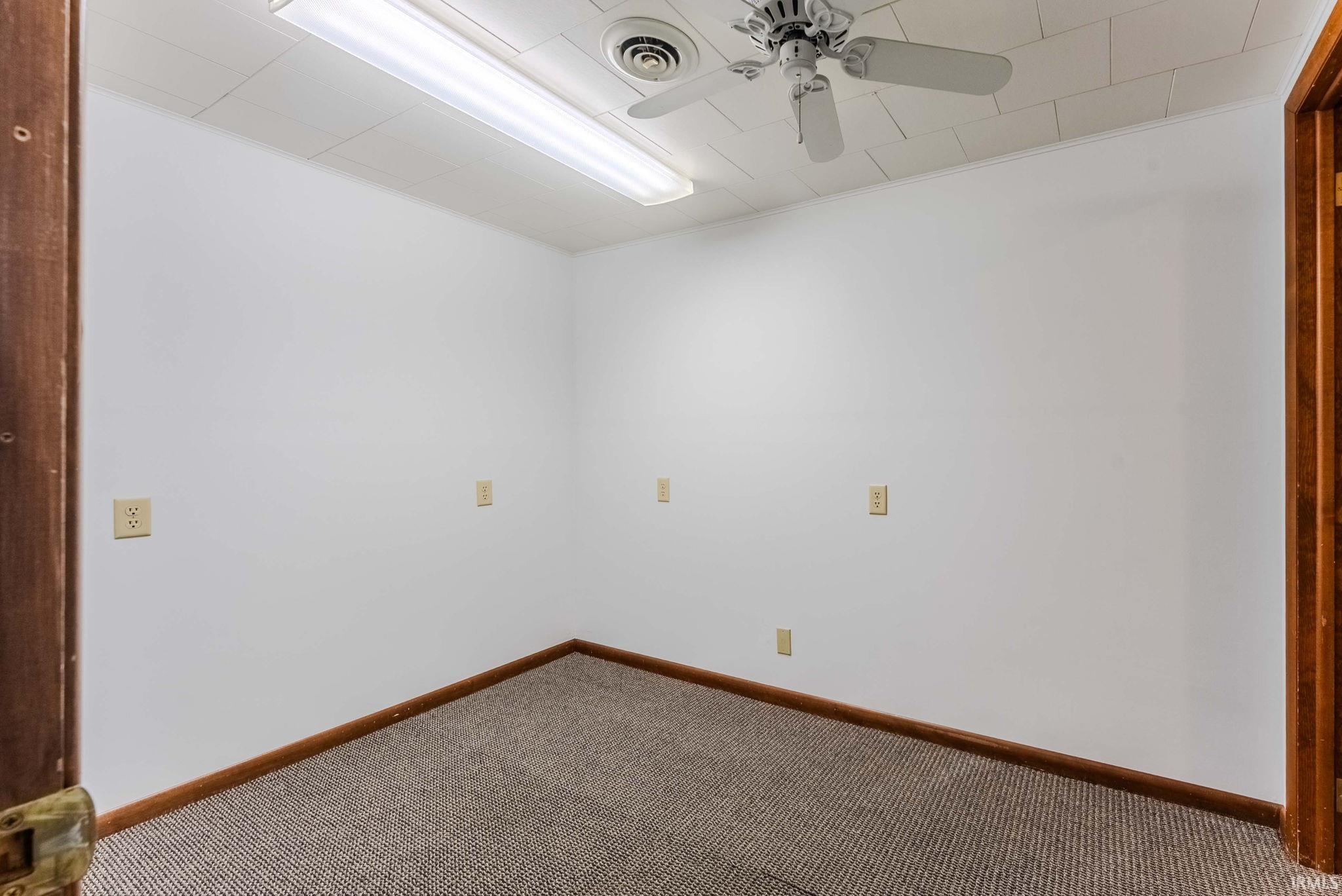Unfurnished room with carpet floors and a ceiling fan