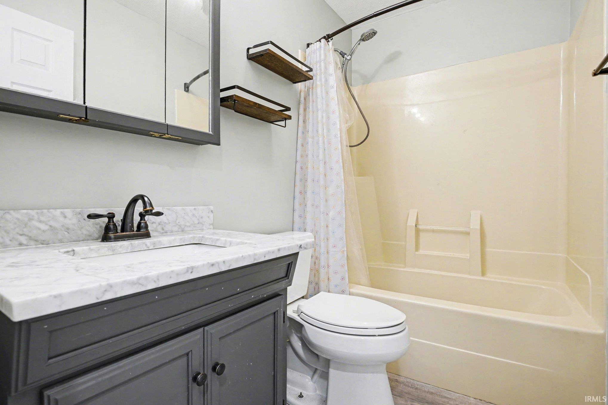Bathroom with vanity and shower/bathtub combination