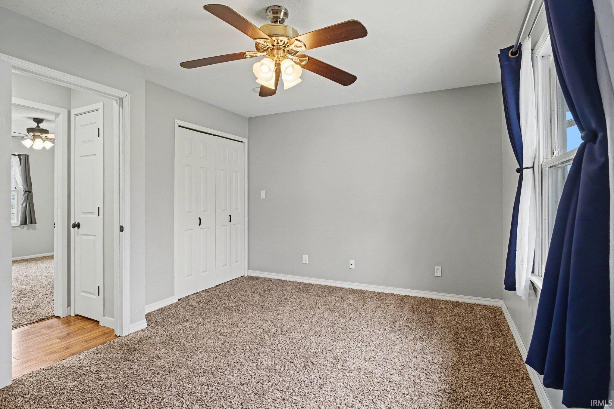 This bedroom also has shelving within the closet.