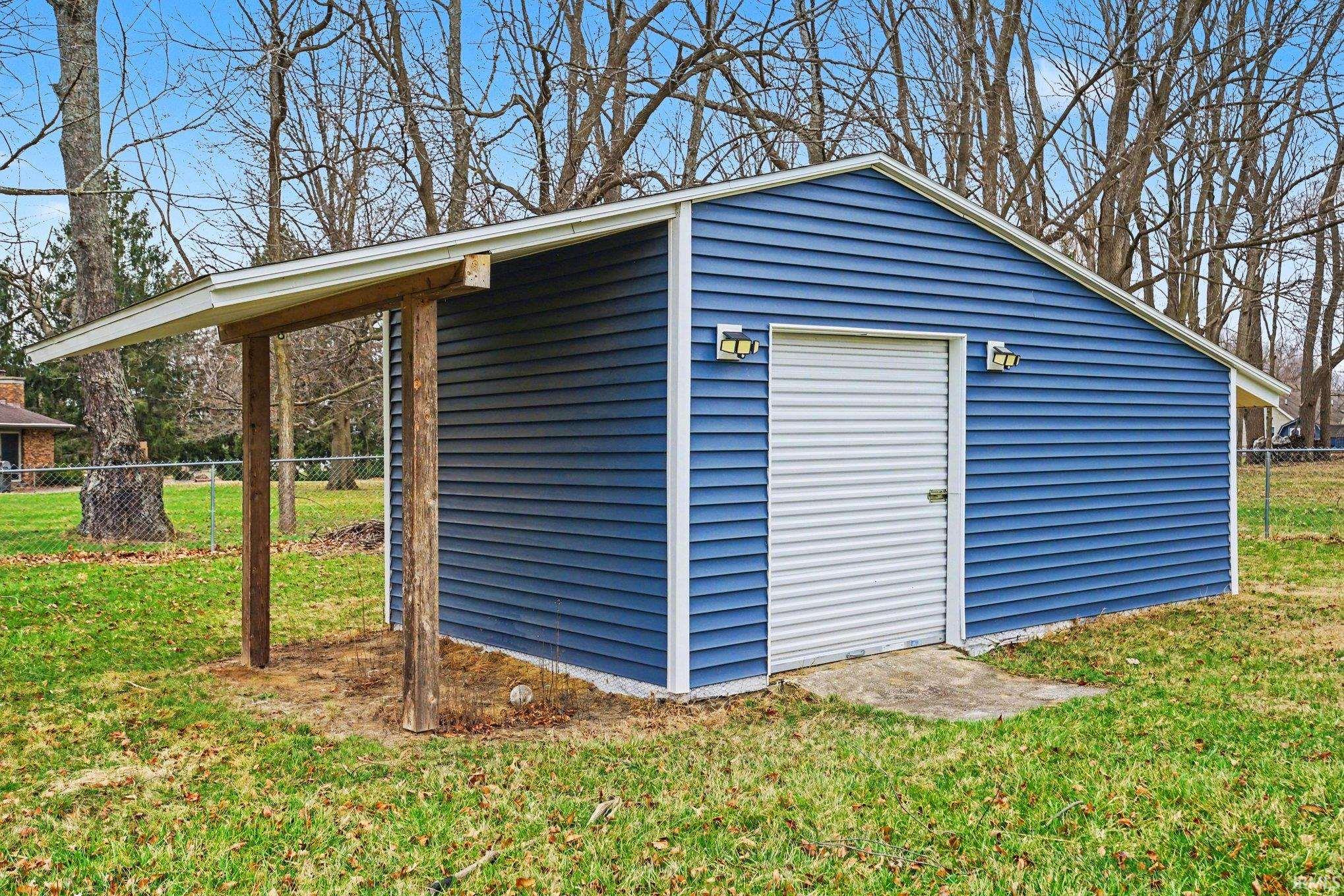 This oversized shed with overhang allows for dry storage of yard equipment and outdoor activity gear.