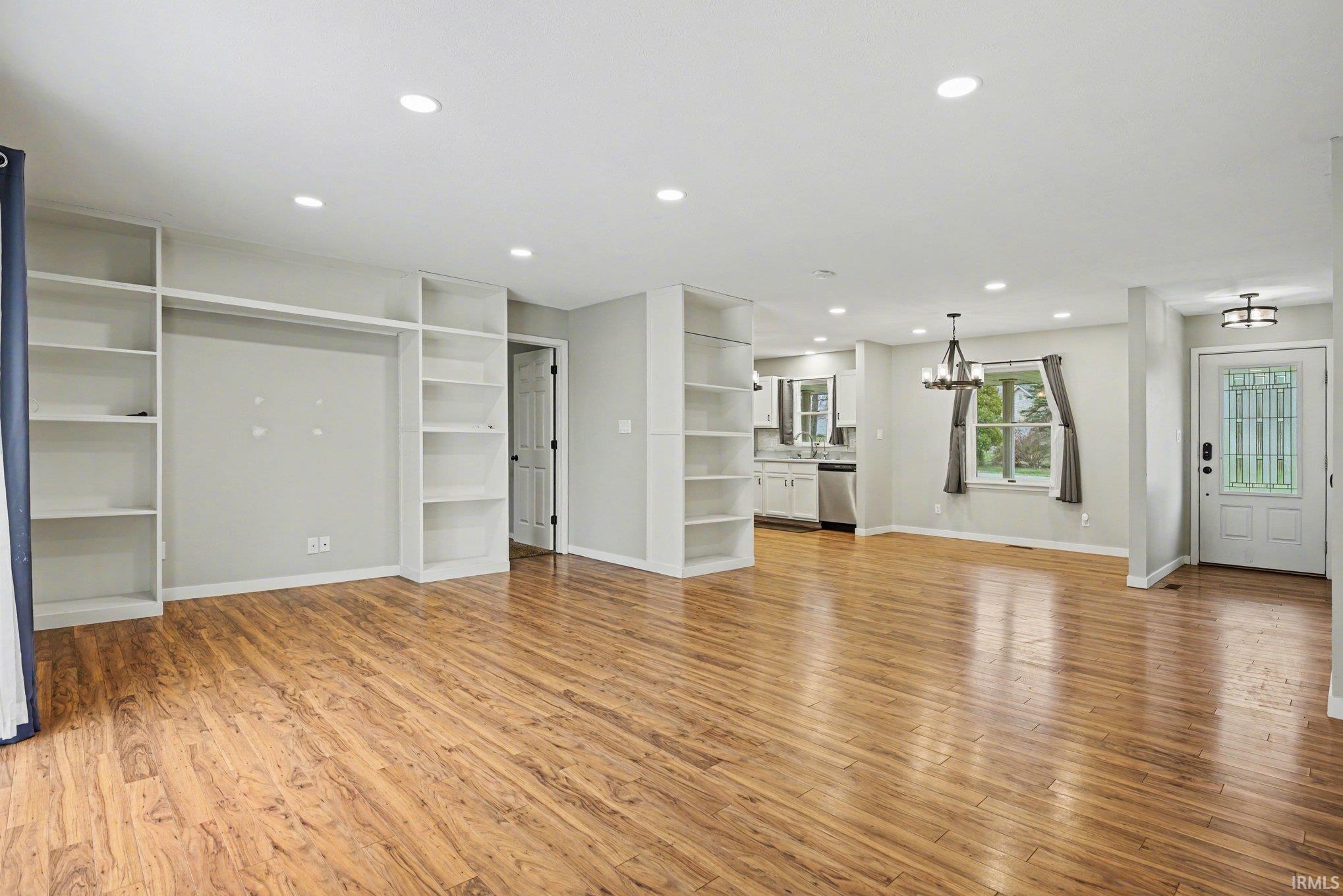 Living room with built-in entertainment and bookshelves