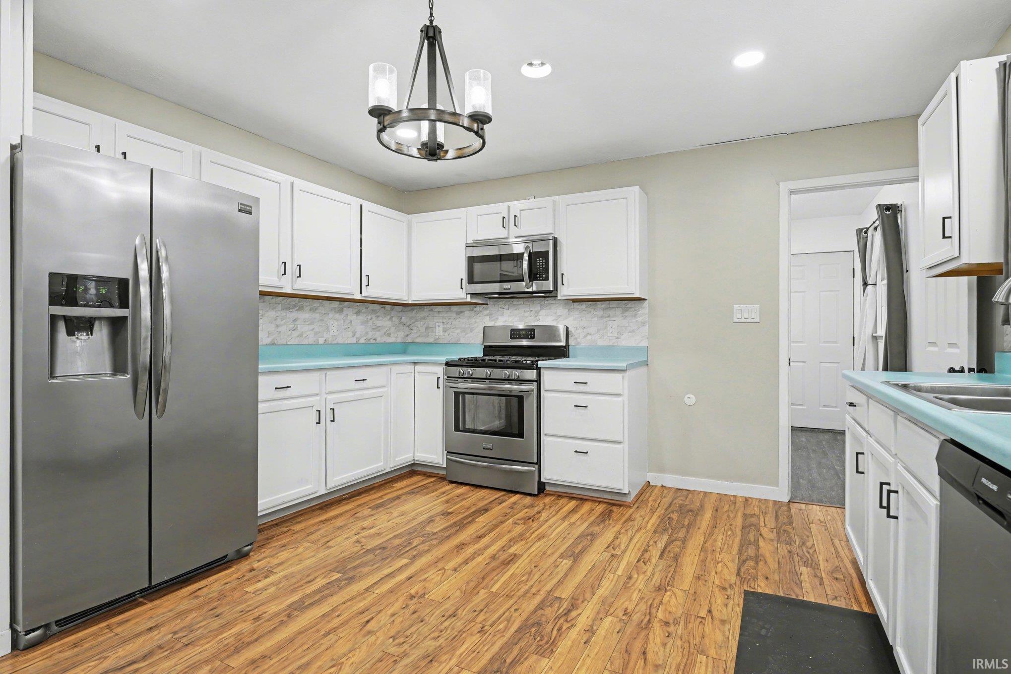 Kitchen featuring white cabinetry and stainless steel appliances