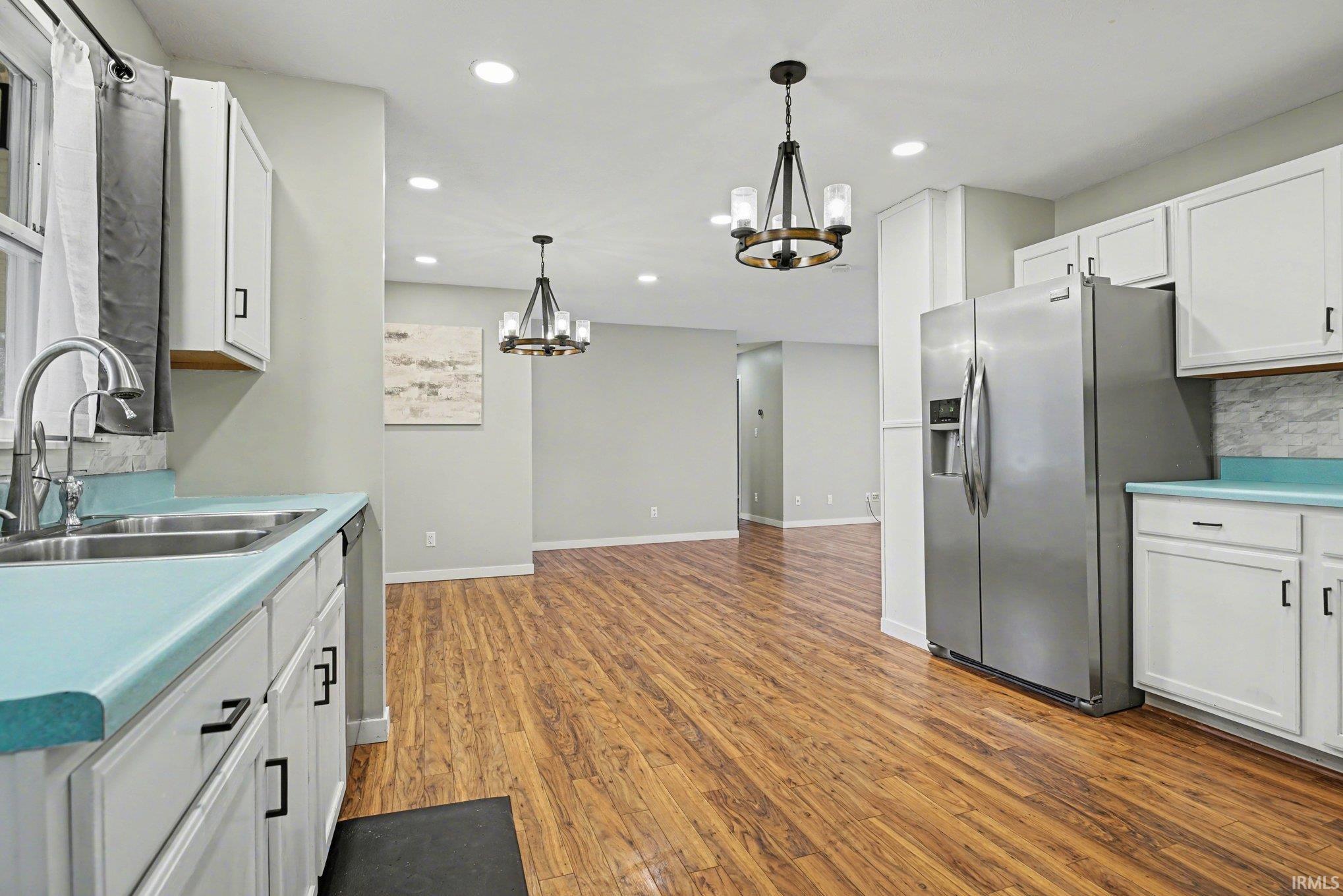 View of kitchen and dining area walking in from the garage