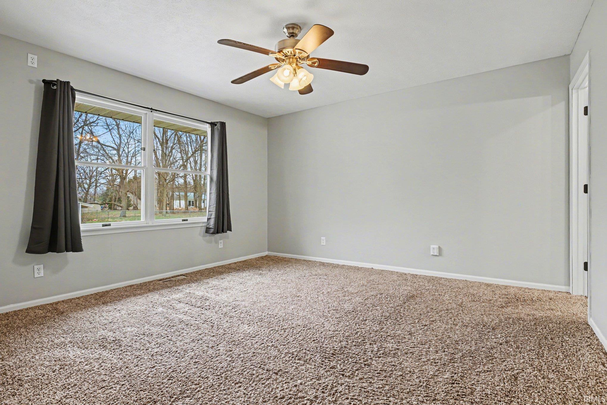 This primary suite is located off from the living room and overlooks the backyard.