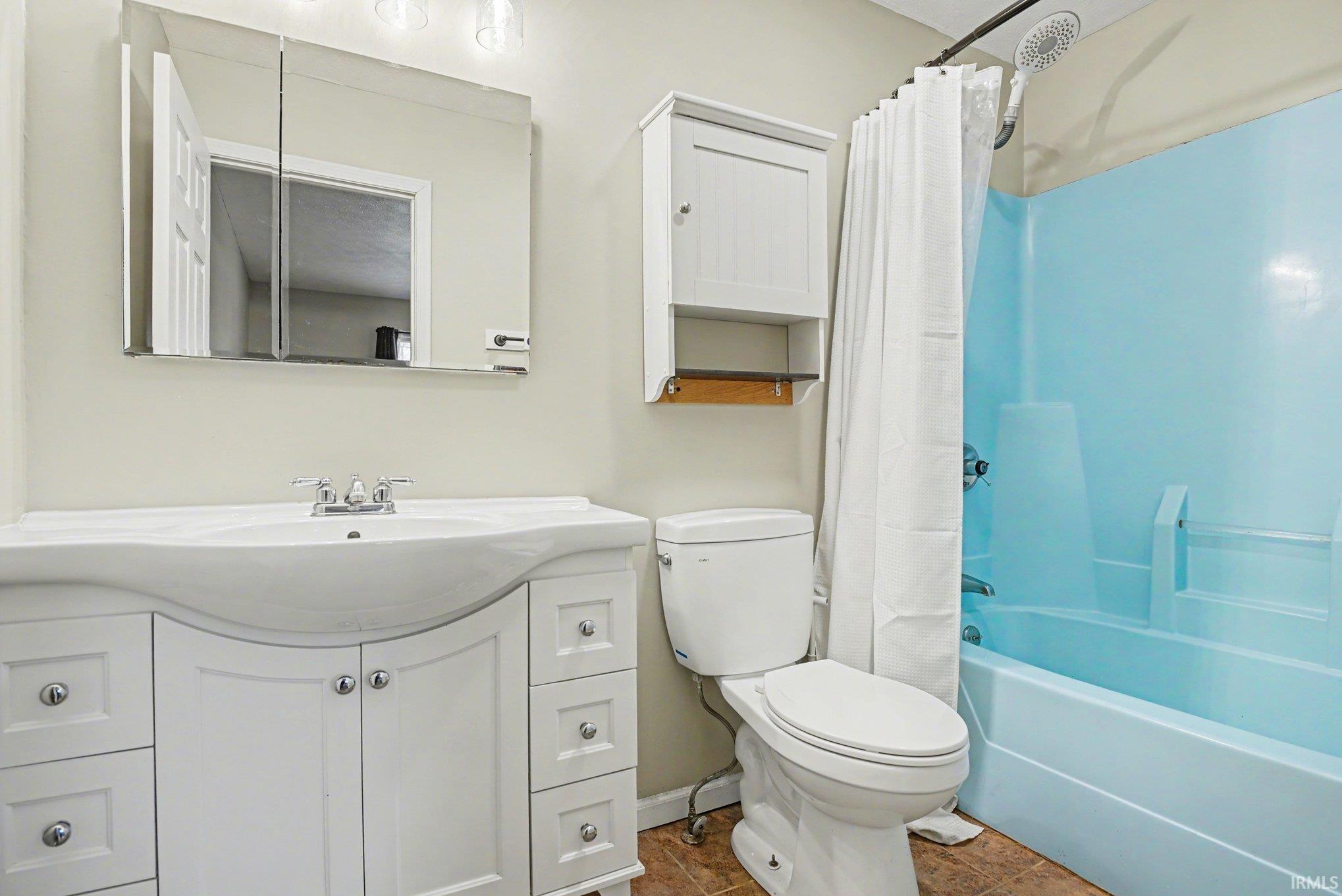 Bathroom featuring vanity and shower/tub combo