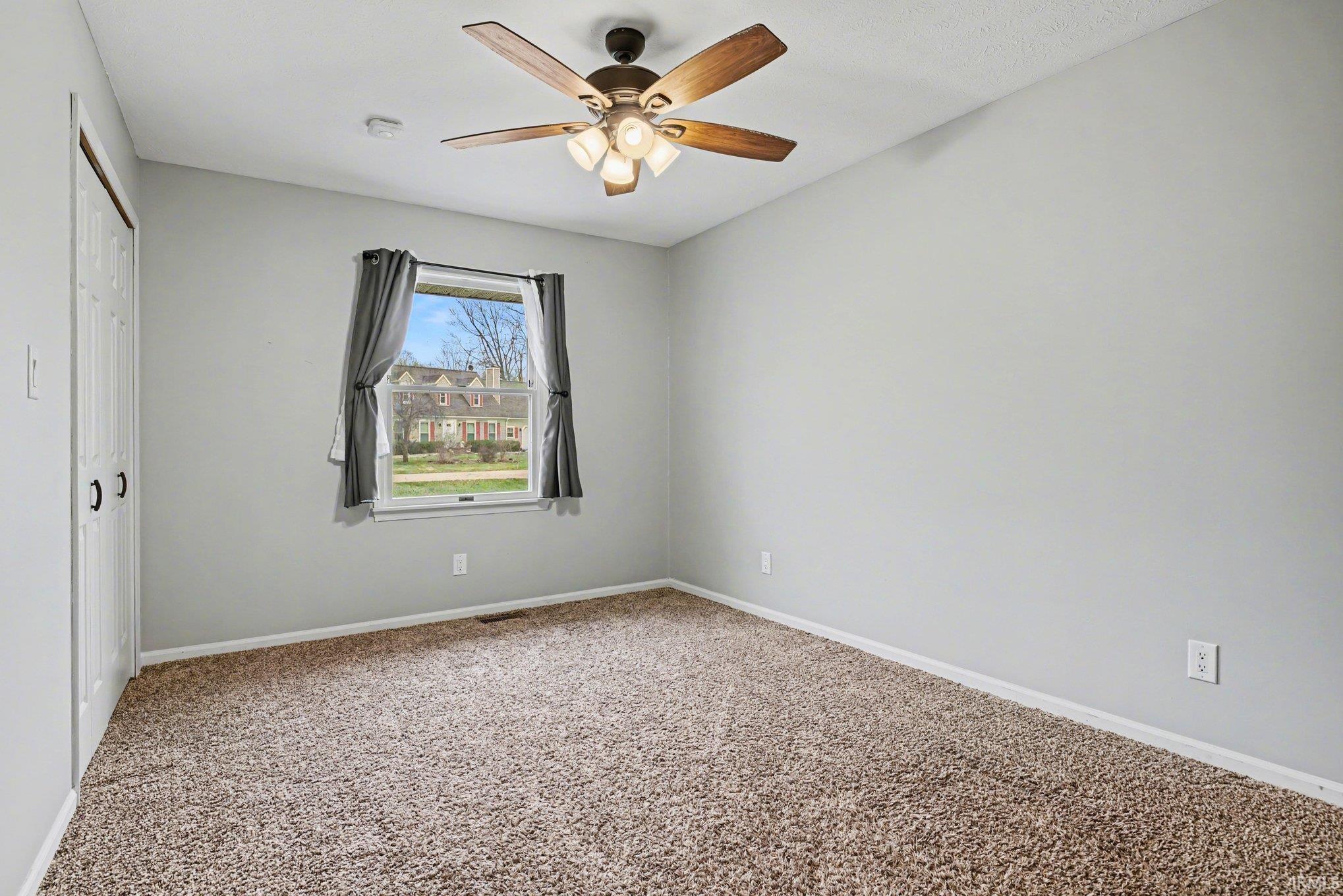 This bedroom has a nice sized closet with shelving.
