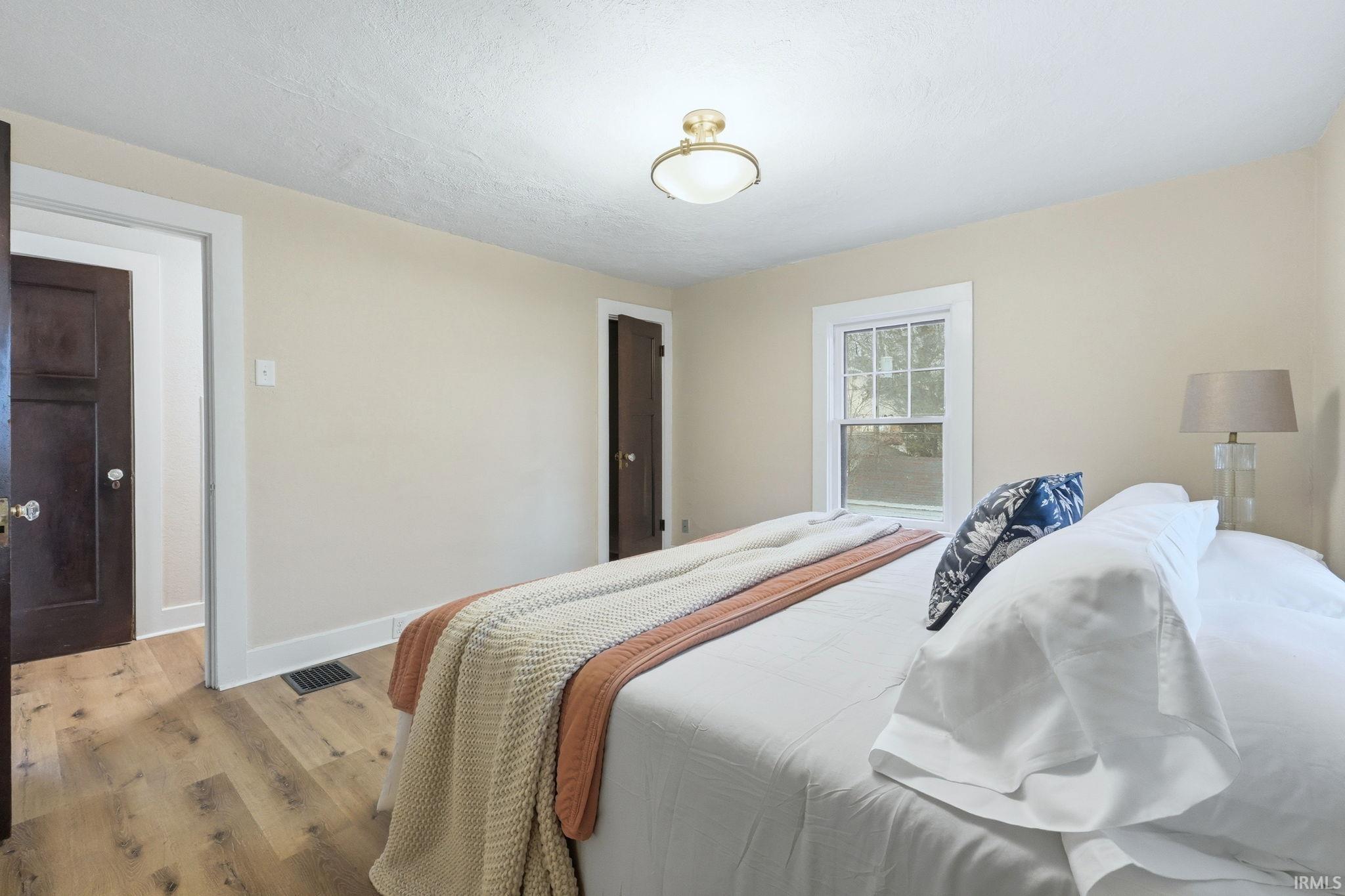 Bedroom featuring baseboards and light wood finished floors