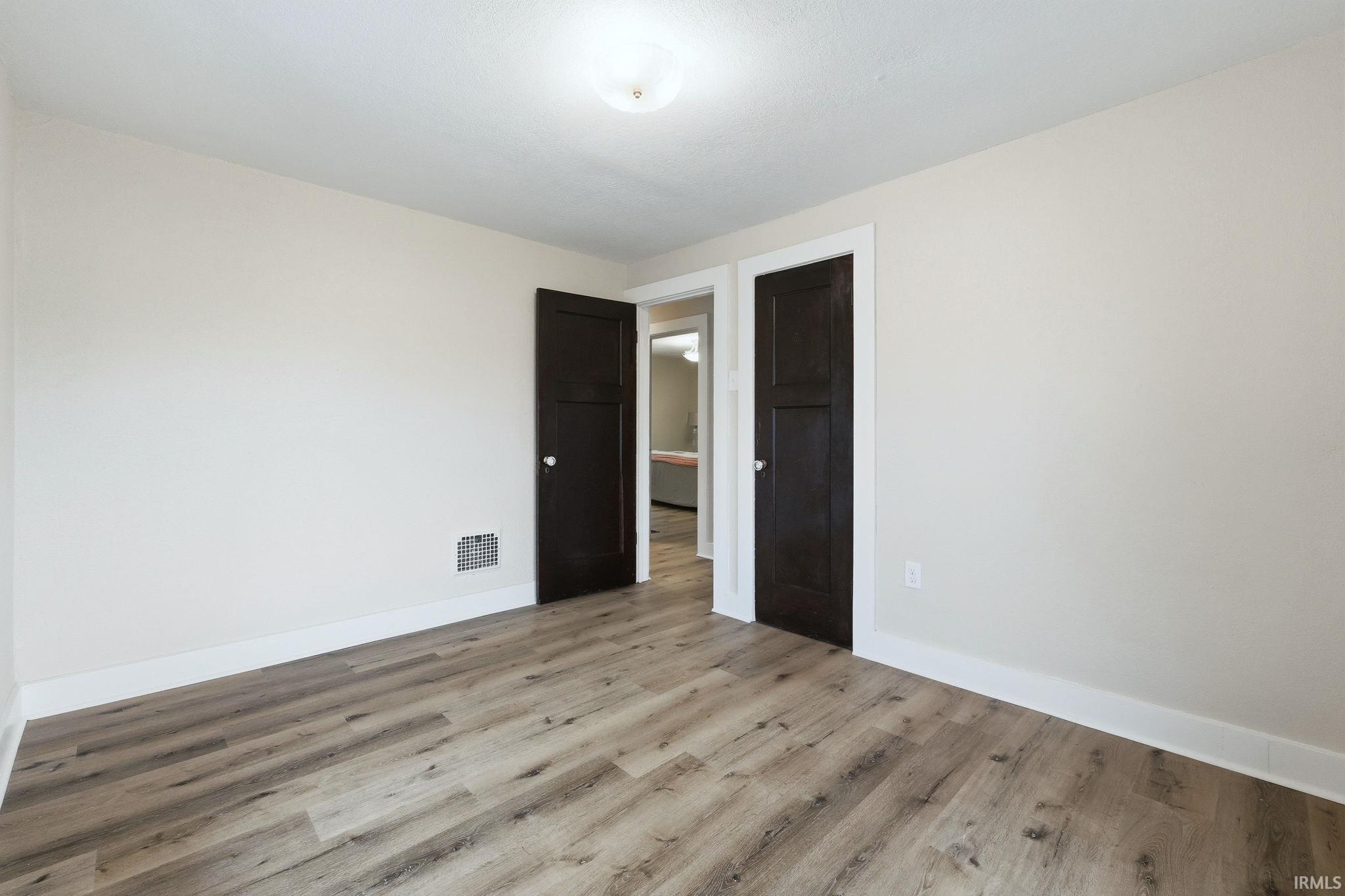 Empty room featuring light wood-type flooring and baseboards