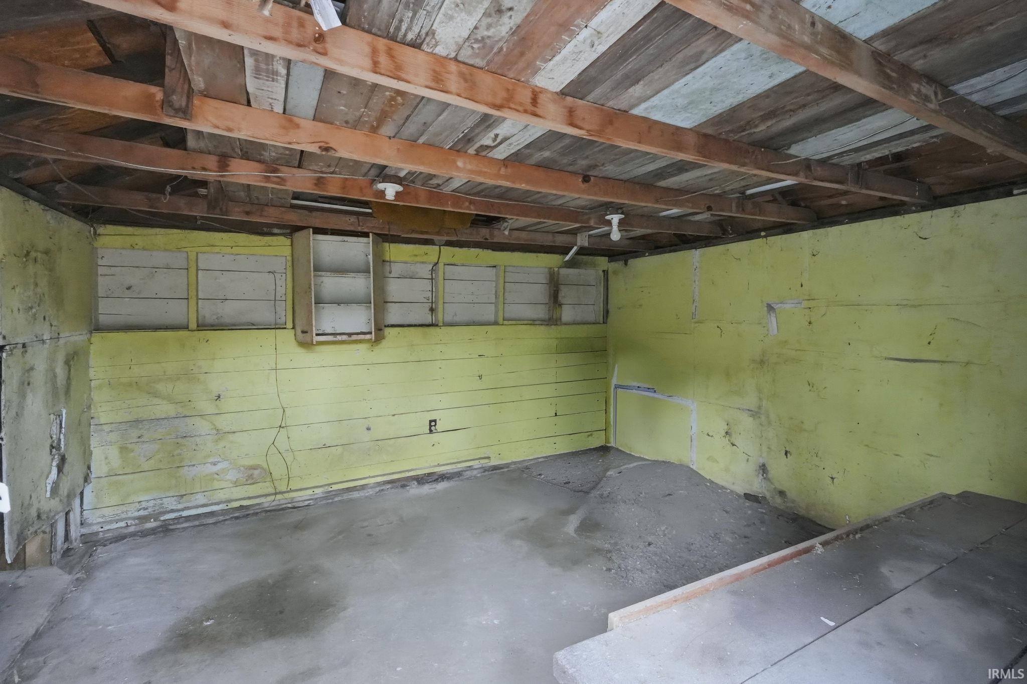 Garage featuring wooden walls