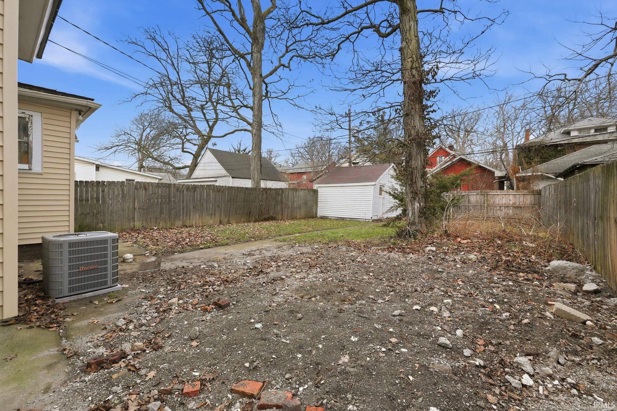 Fenced backyard with a storage shed
