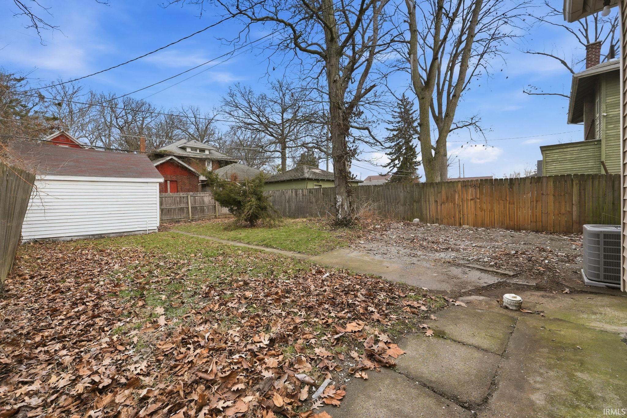Fenced backyard with an outdoor structure