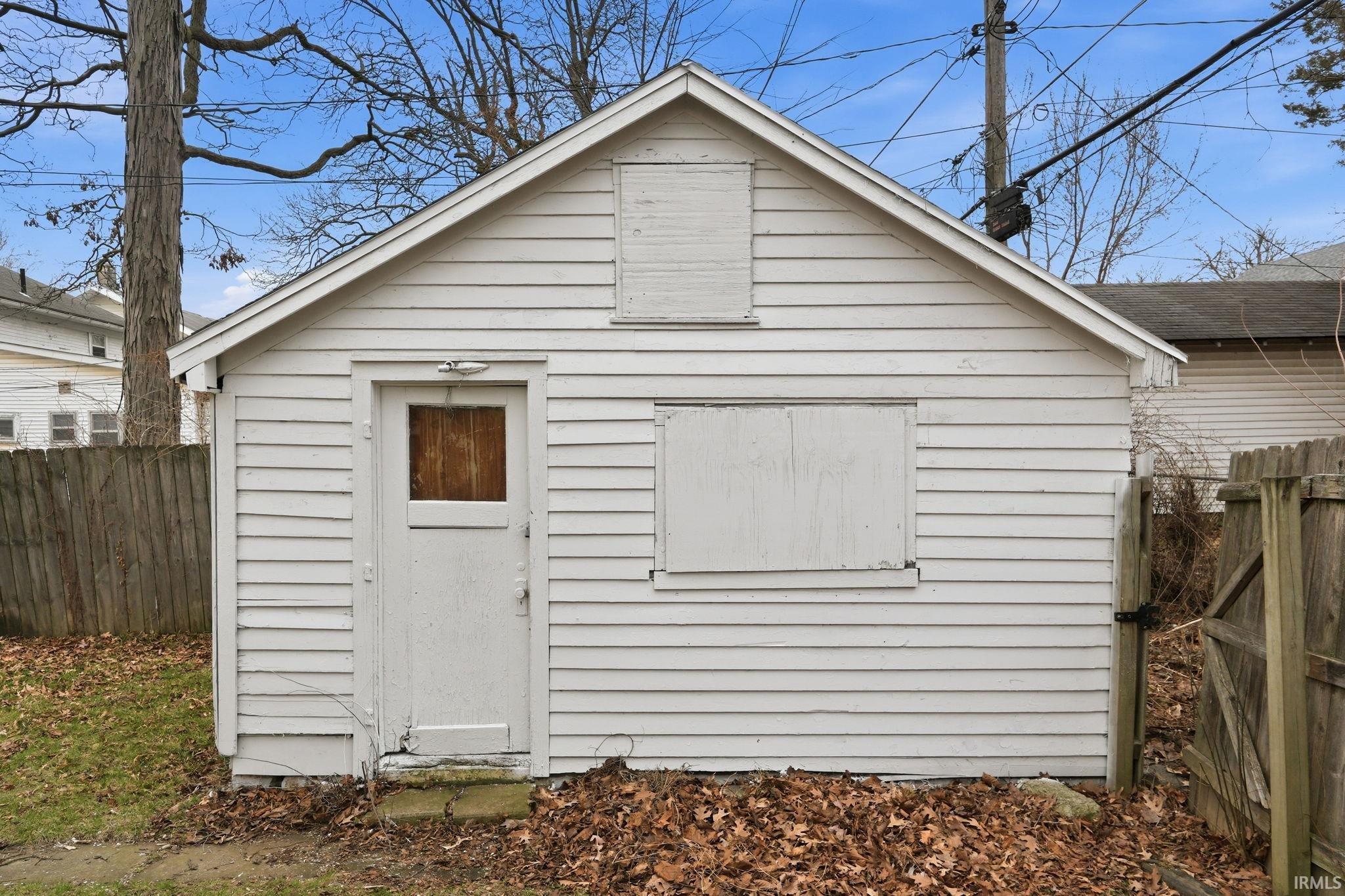 View of shed with a fenced backyard