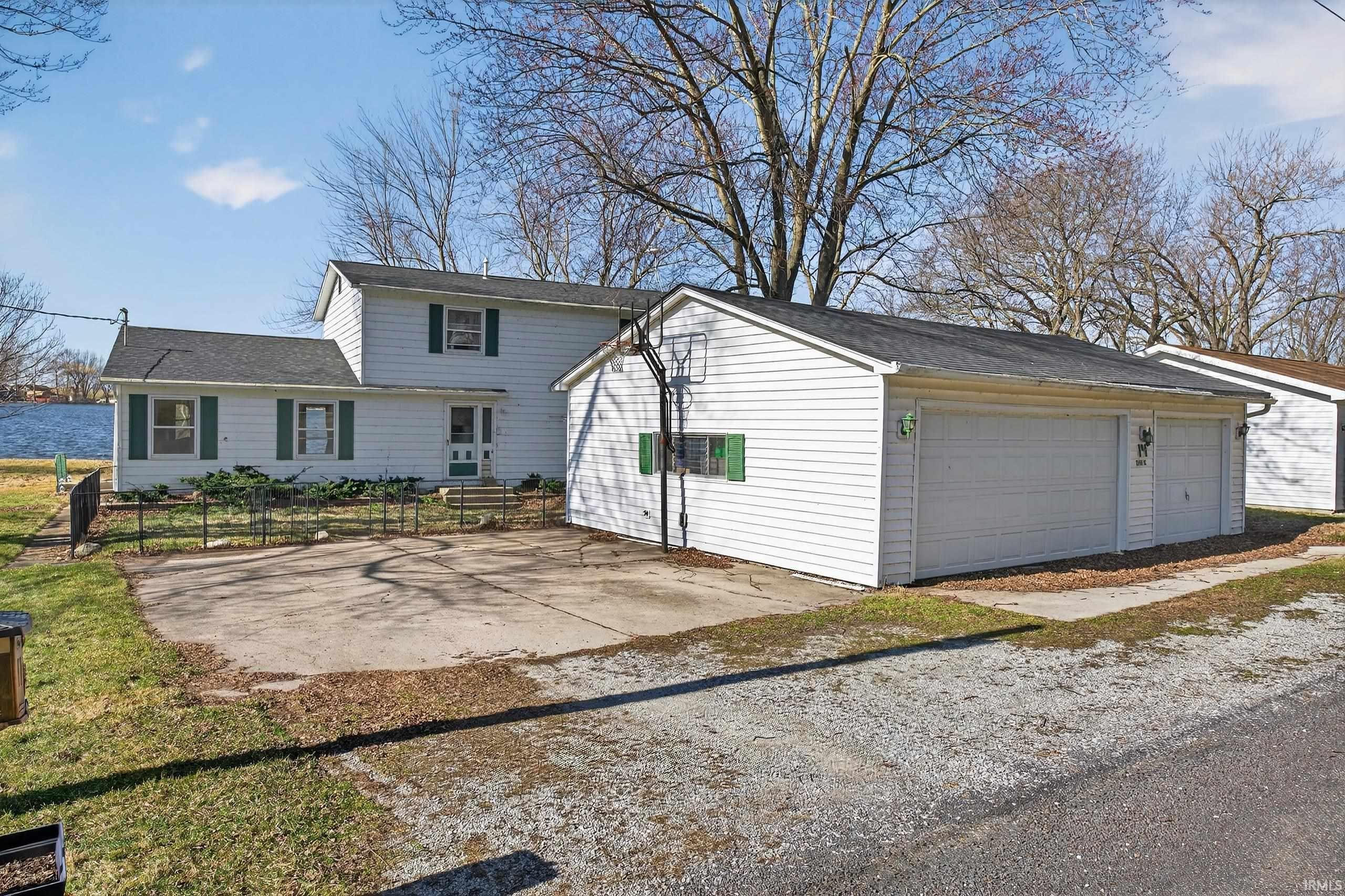 View of front of house with a garage and a patio area