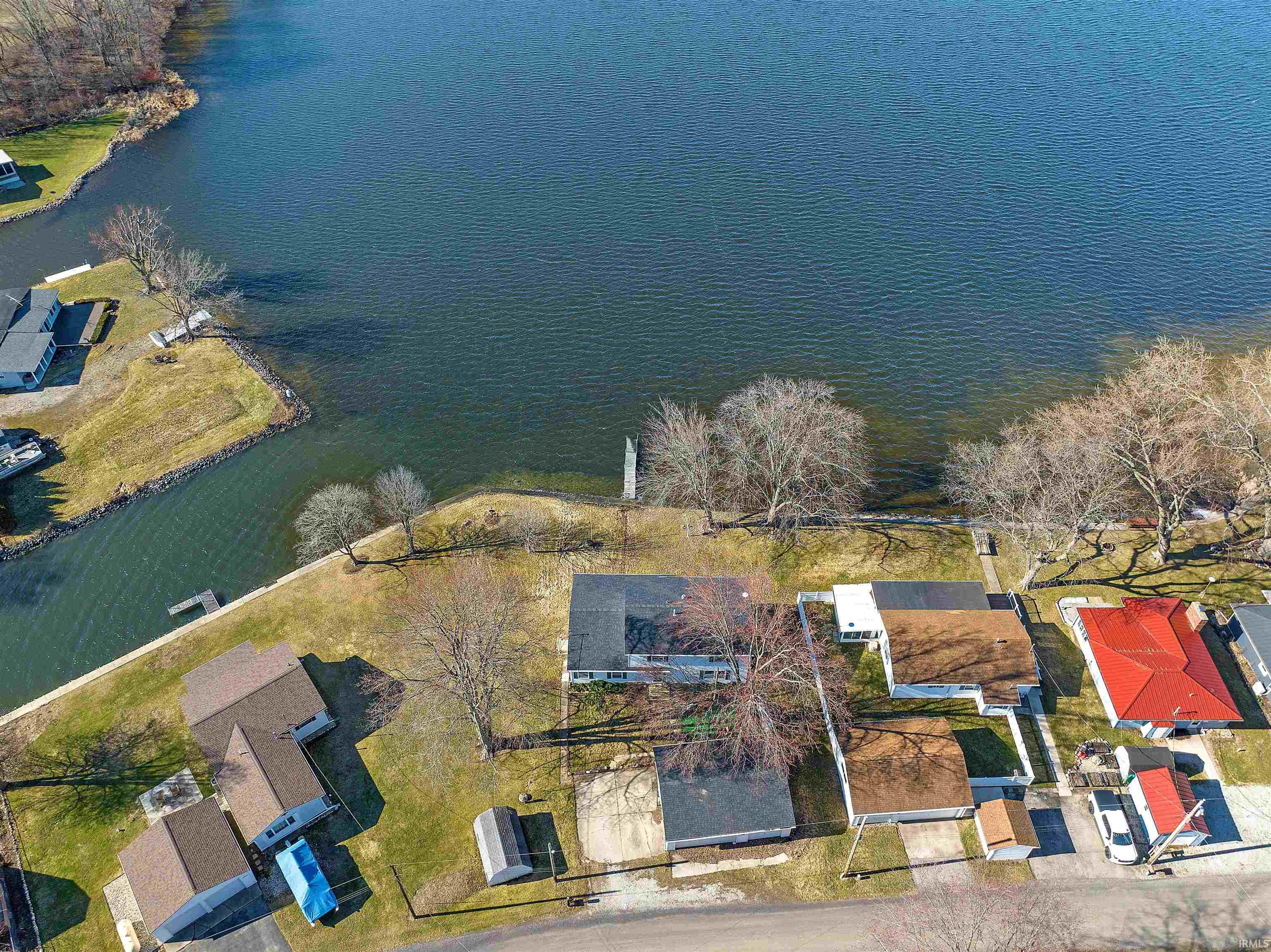 Aerial perspective of suburban area featuring a large body of water