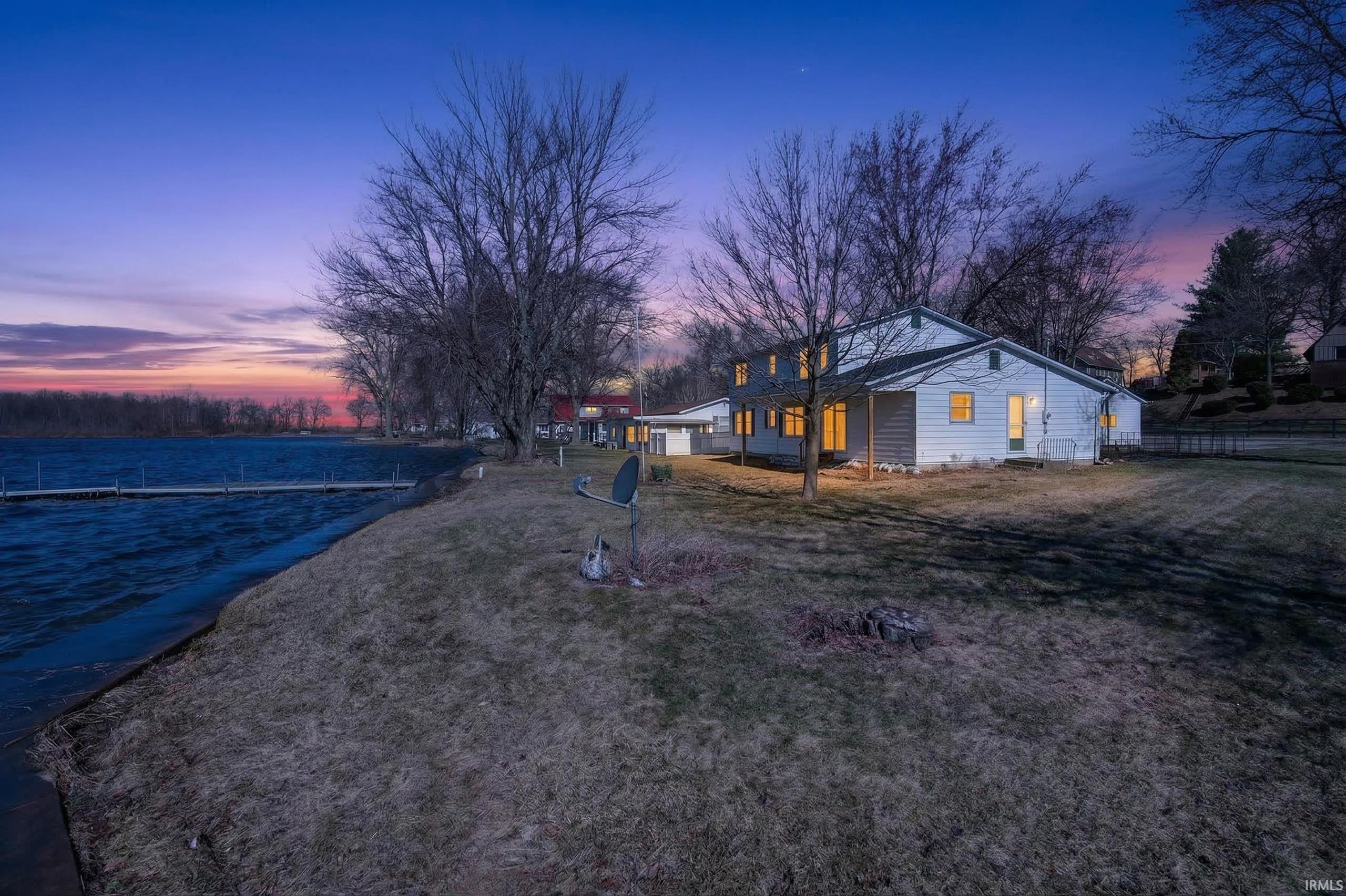 View of front of home featuring a water view and a yard