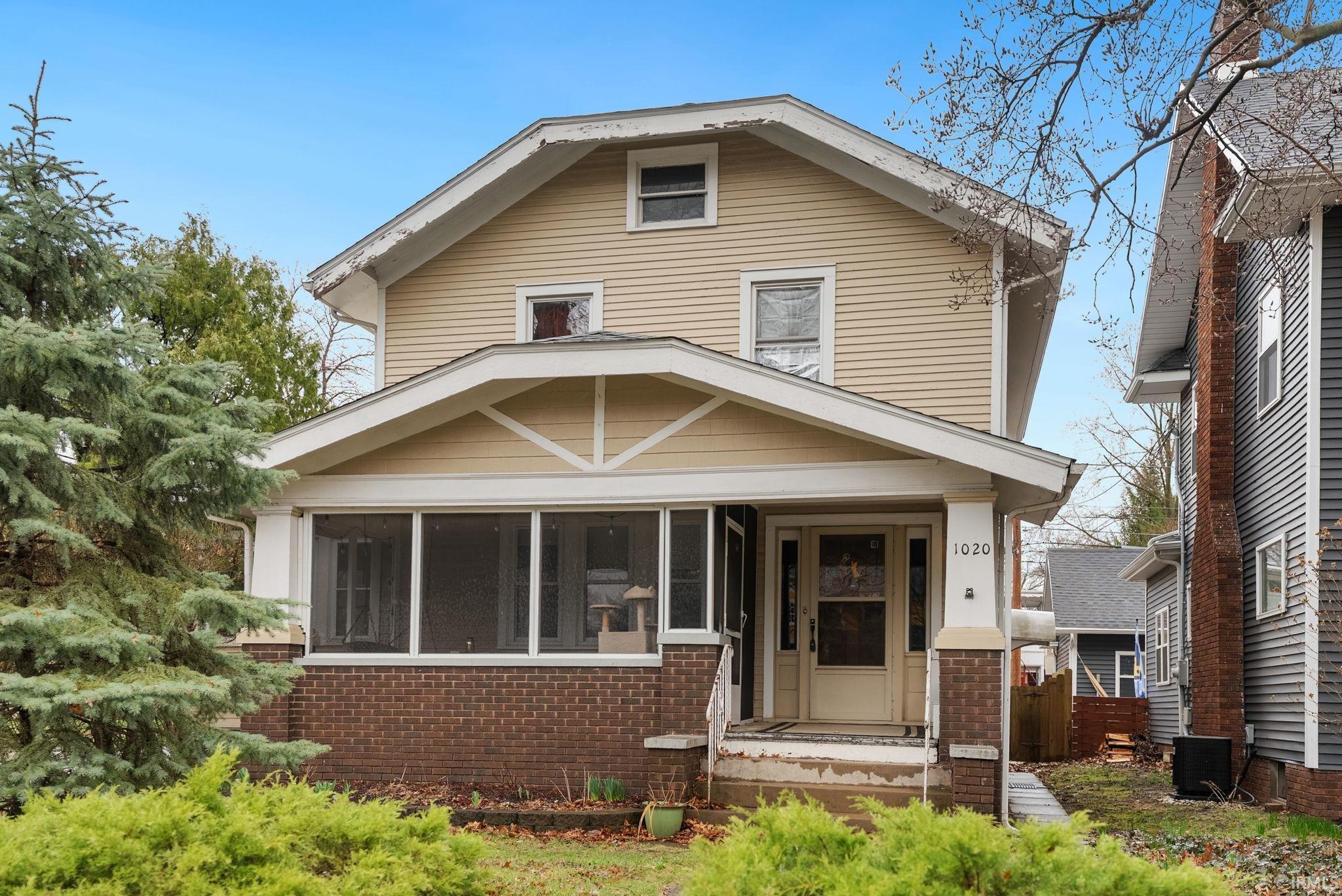 Traditional style home with brick siding and a sunroom