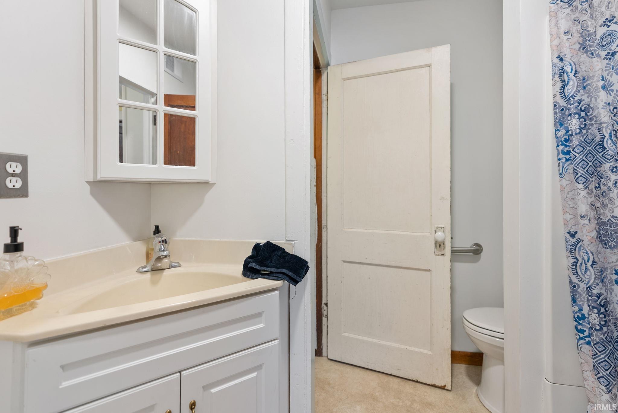 Full bathroom with vanity and curtained shower