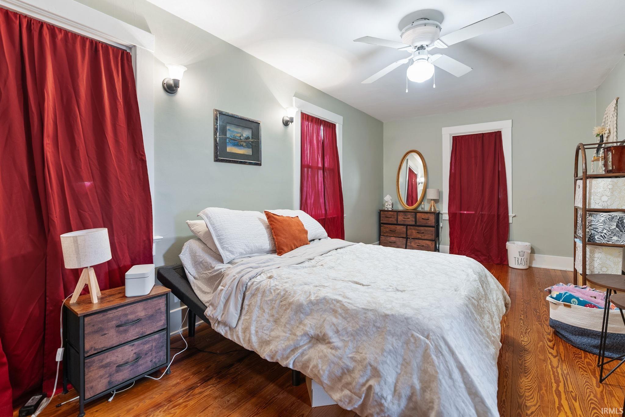 Bedroom with wood finished floors and ceiling fan