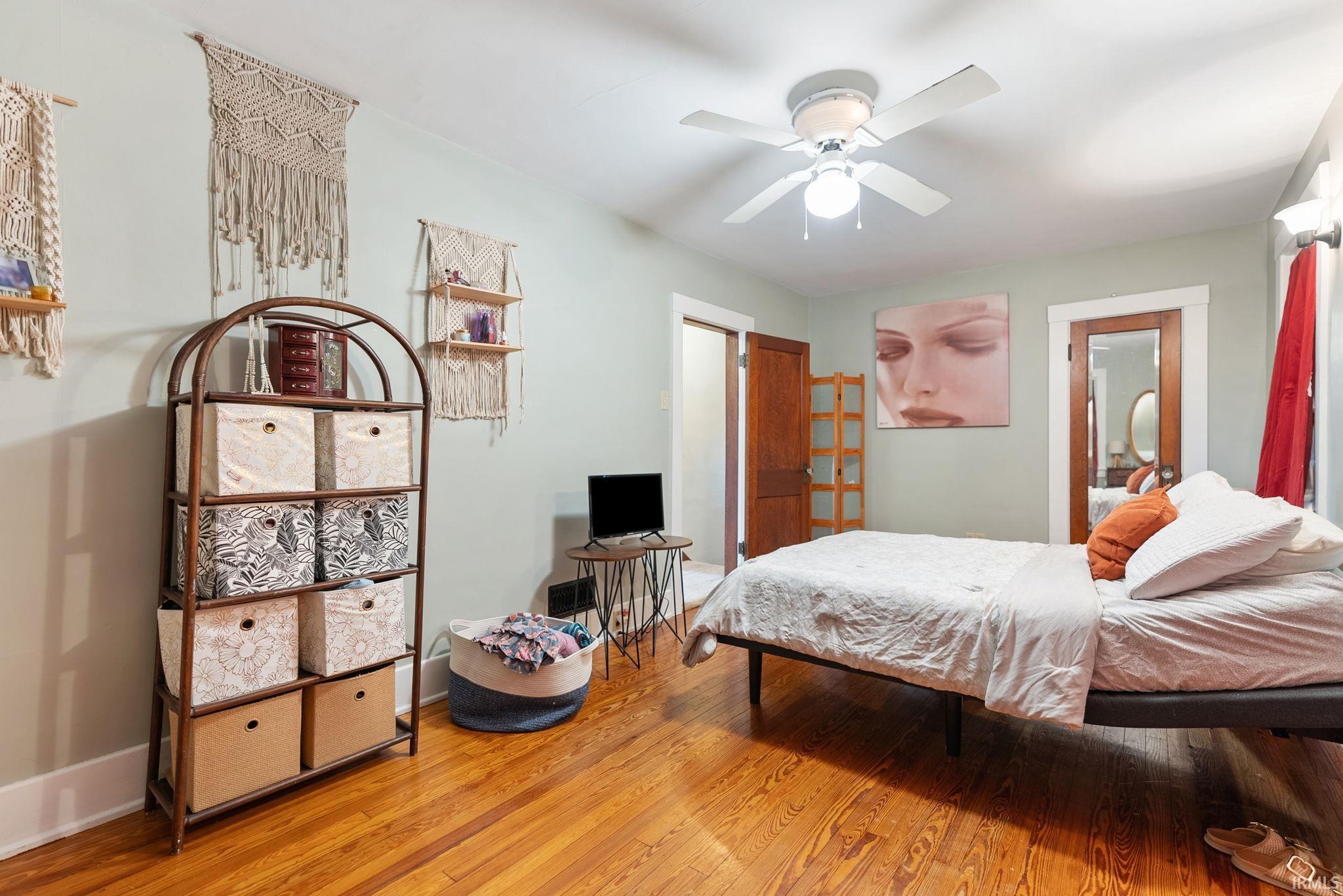 Bedroom with light wood-type flooring and ceiling fan
