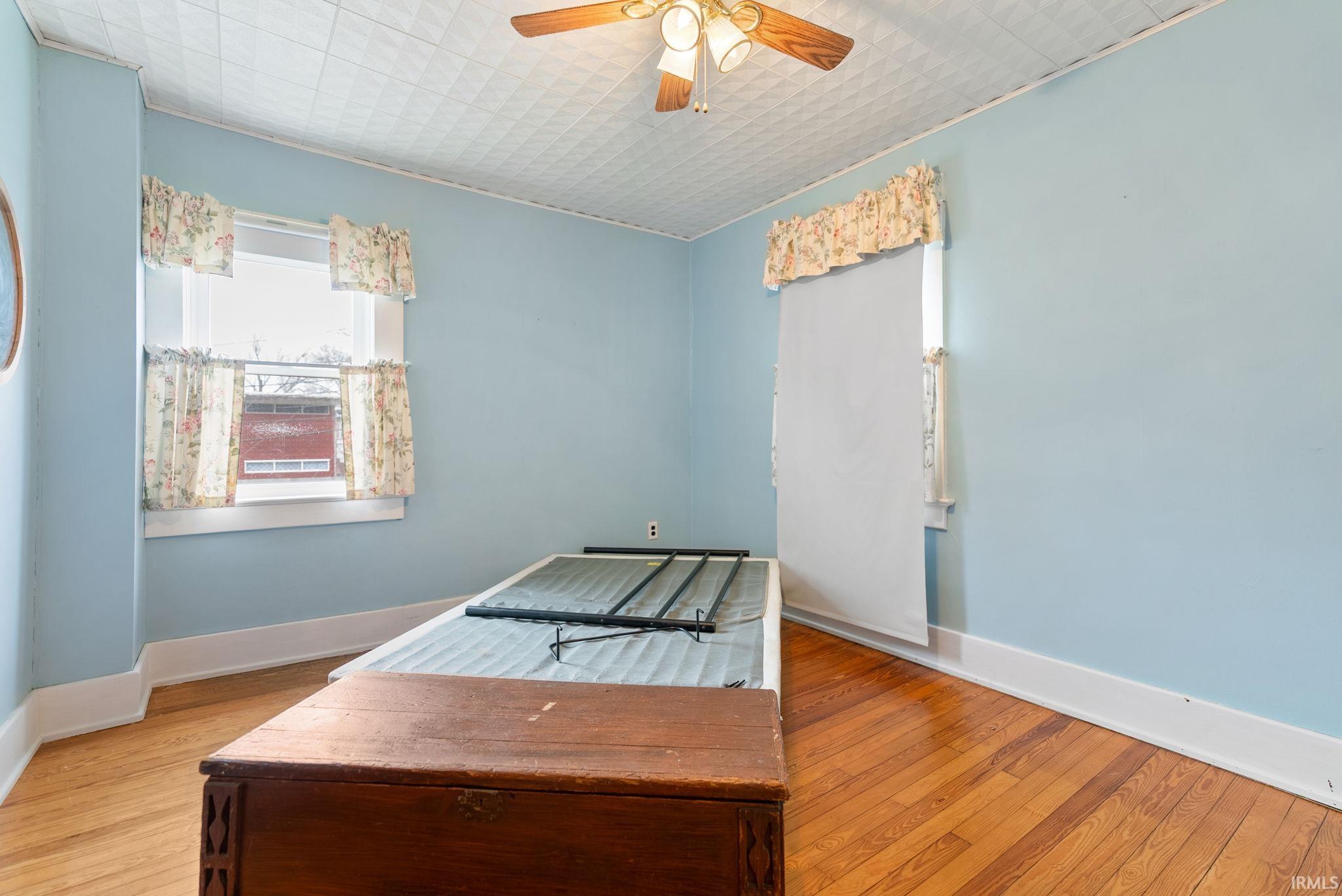 Unfurnished bedroom featuring light wood-type flooring and a ceiling fan