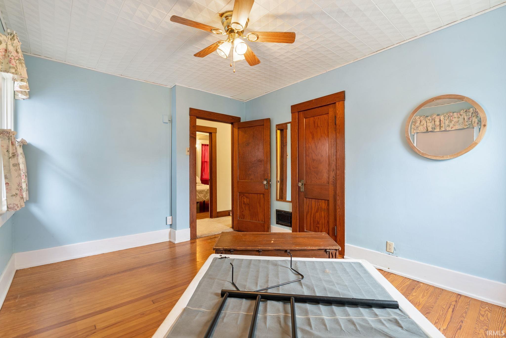 Bedroom with light wood-style floors and ceiling fan