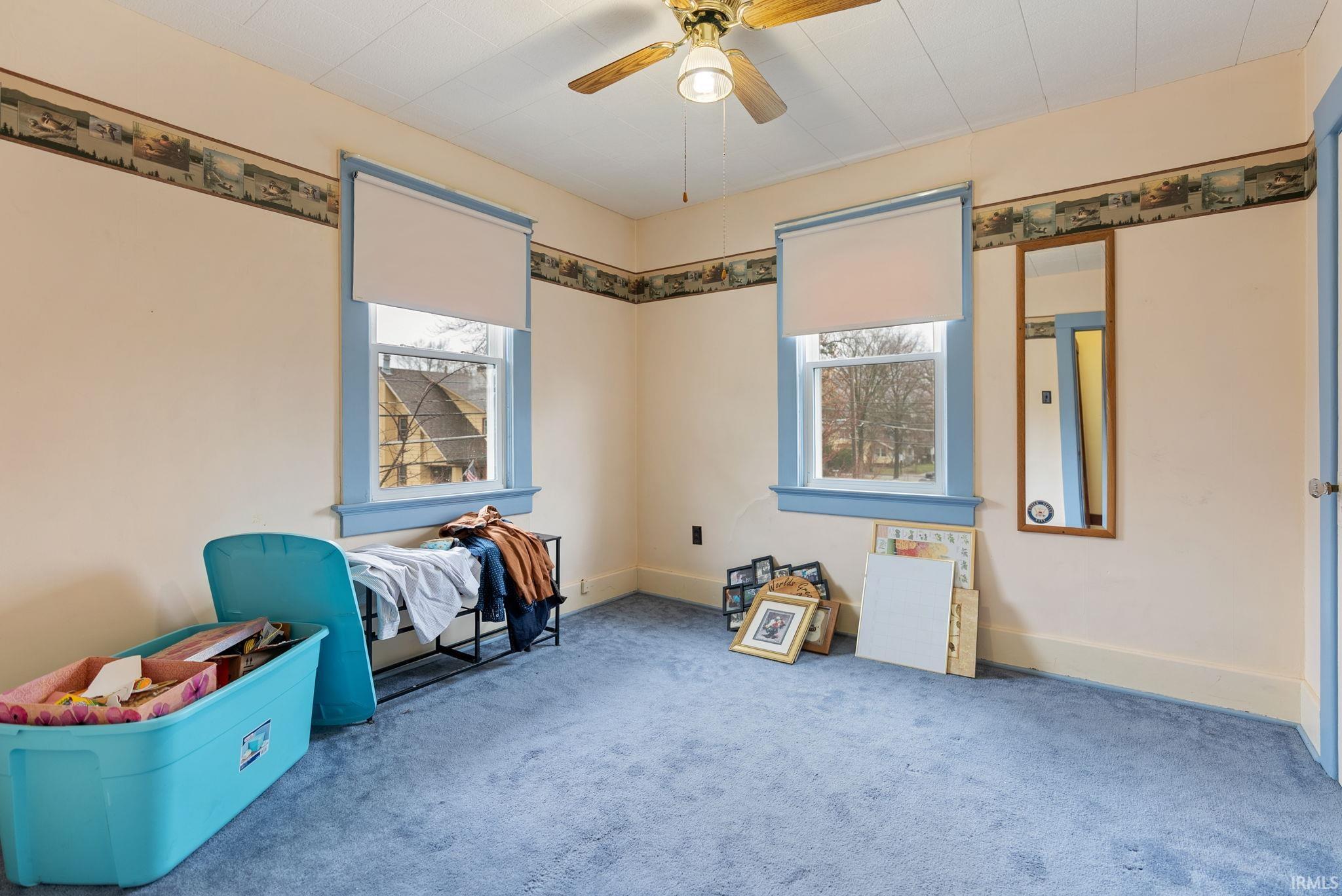 Unfurnished bedroom featuring carpet flooring and a ceiling fan