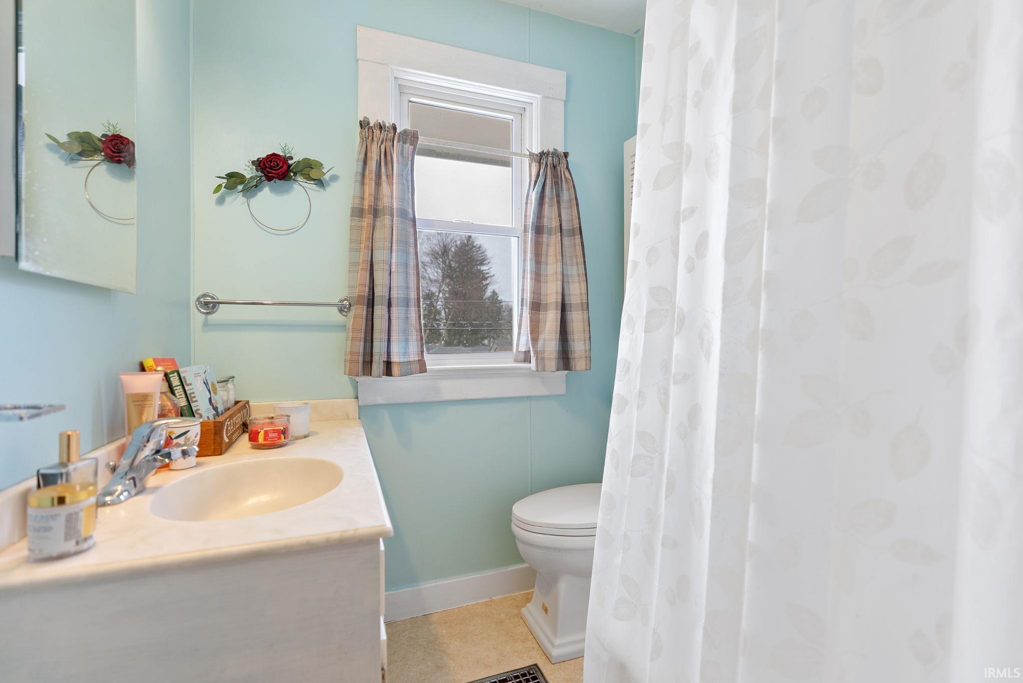 Bathroom with vanity and curtained shower