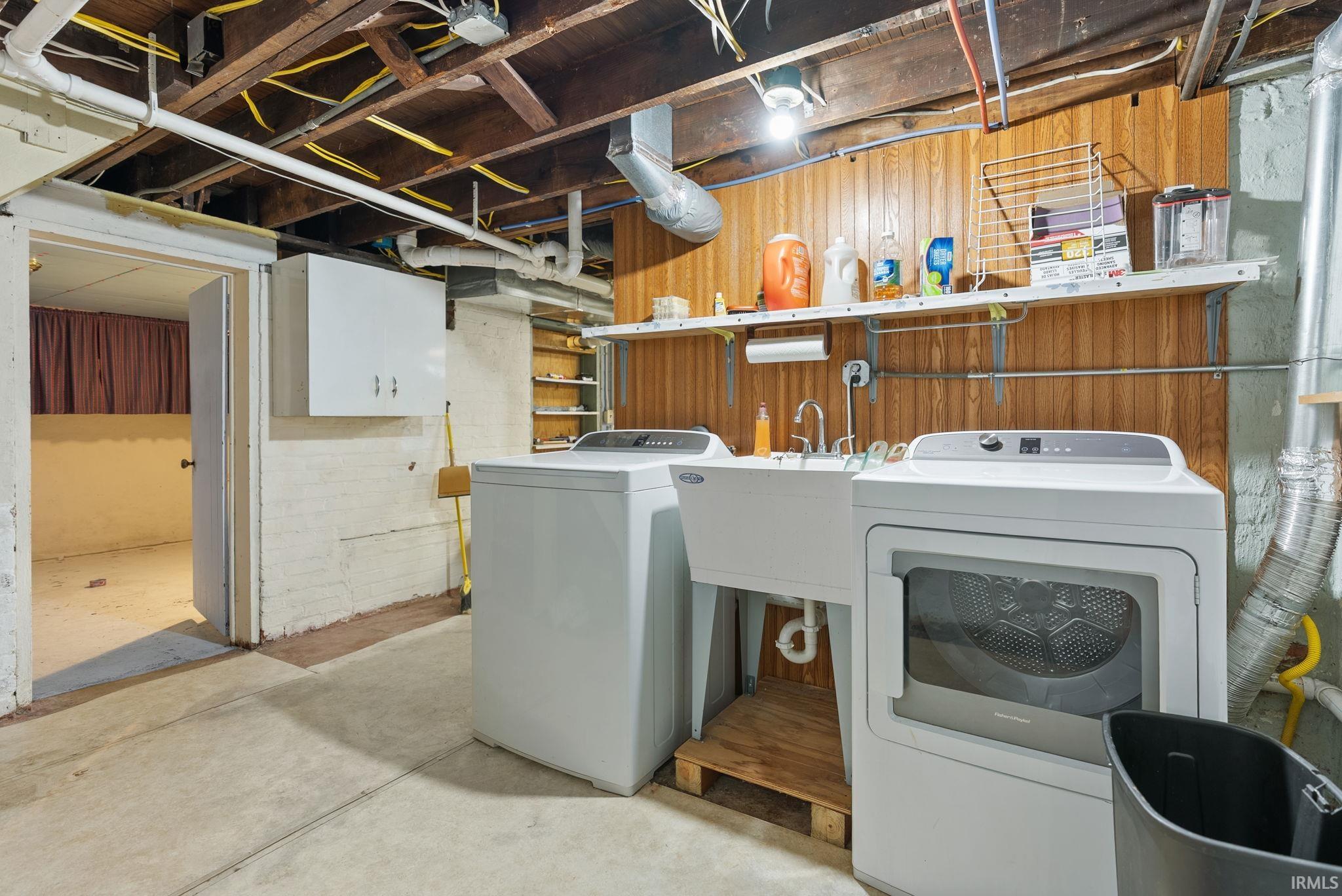 Laundry area featuring concrete floors and separate washer and dryer