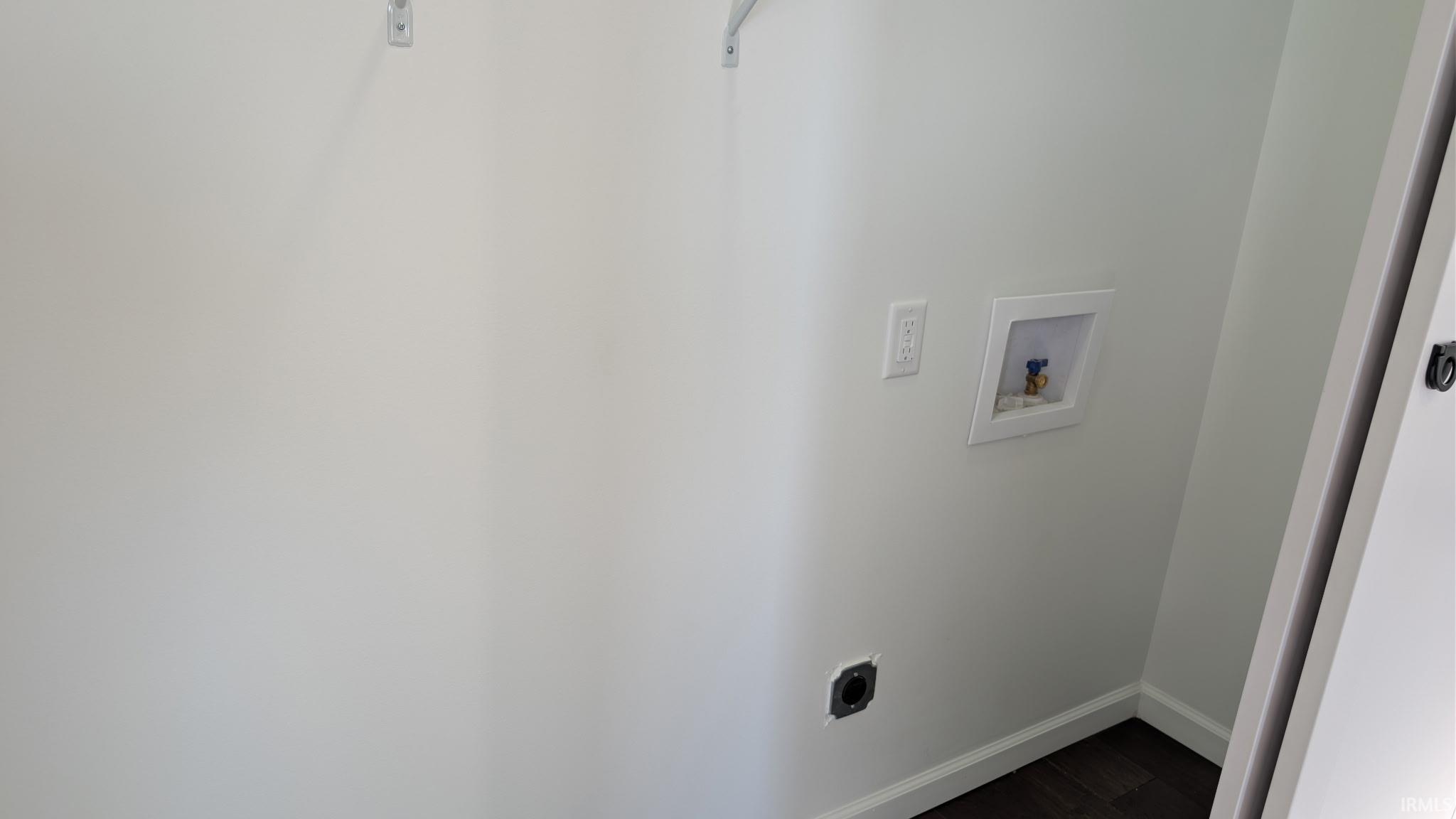 Laundry area with dark wood-style flooring, hookup for a washing machine, and electric dryer hookup