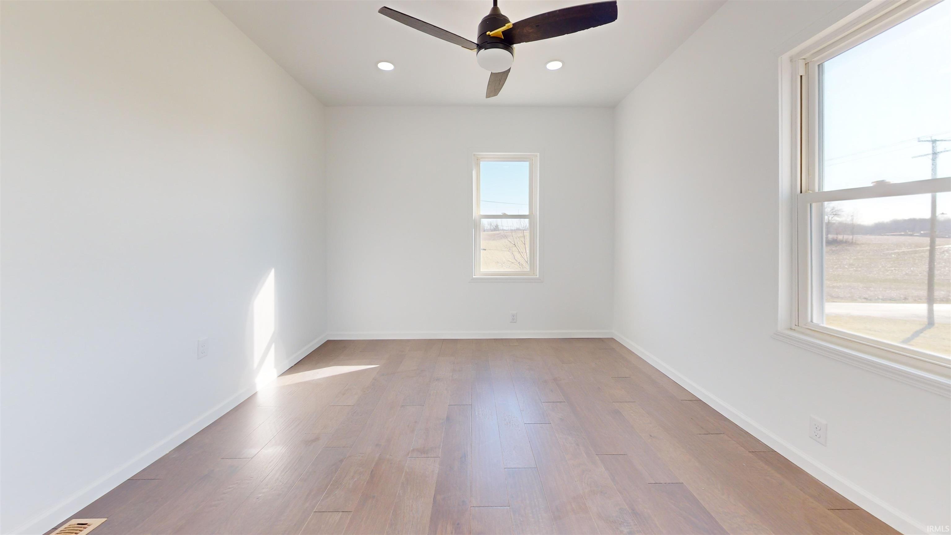 Empty room featuring a ceiling fan, light wood-style flooring, and recessed lighting