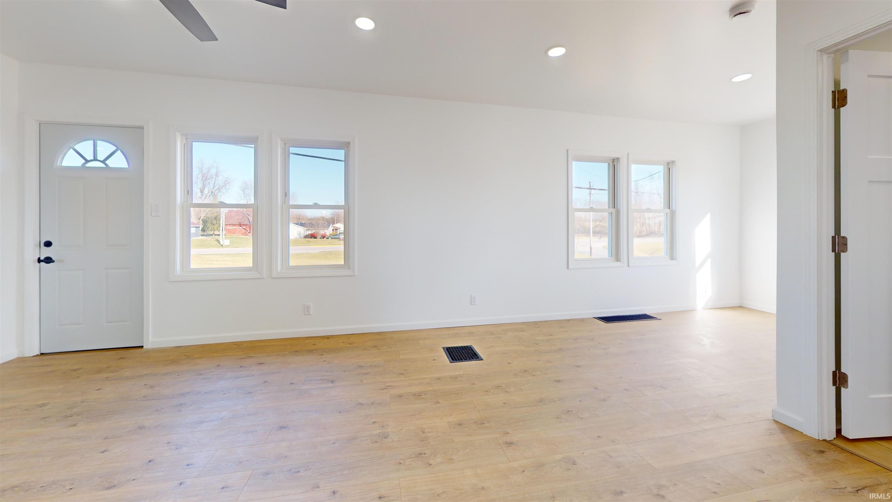 Entrance foyer with light wood-type flooring, recessed lighting, and ceiling fan