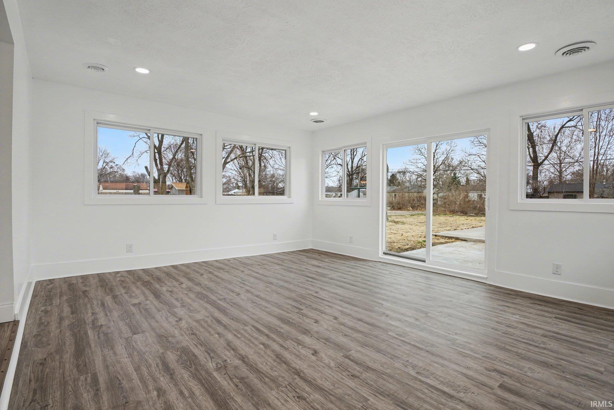 wood-style flooring and recessed lighting