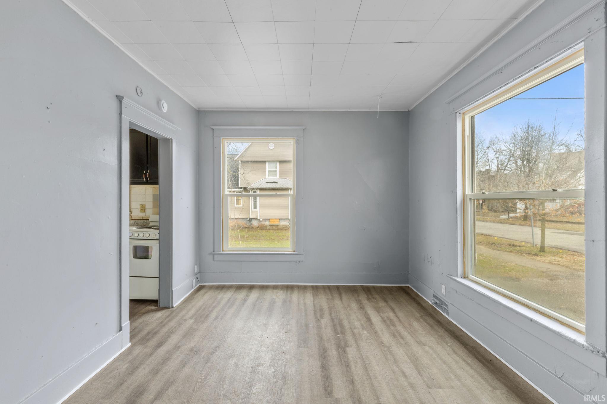 Spare room featuring light wood-style floors and baseboards