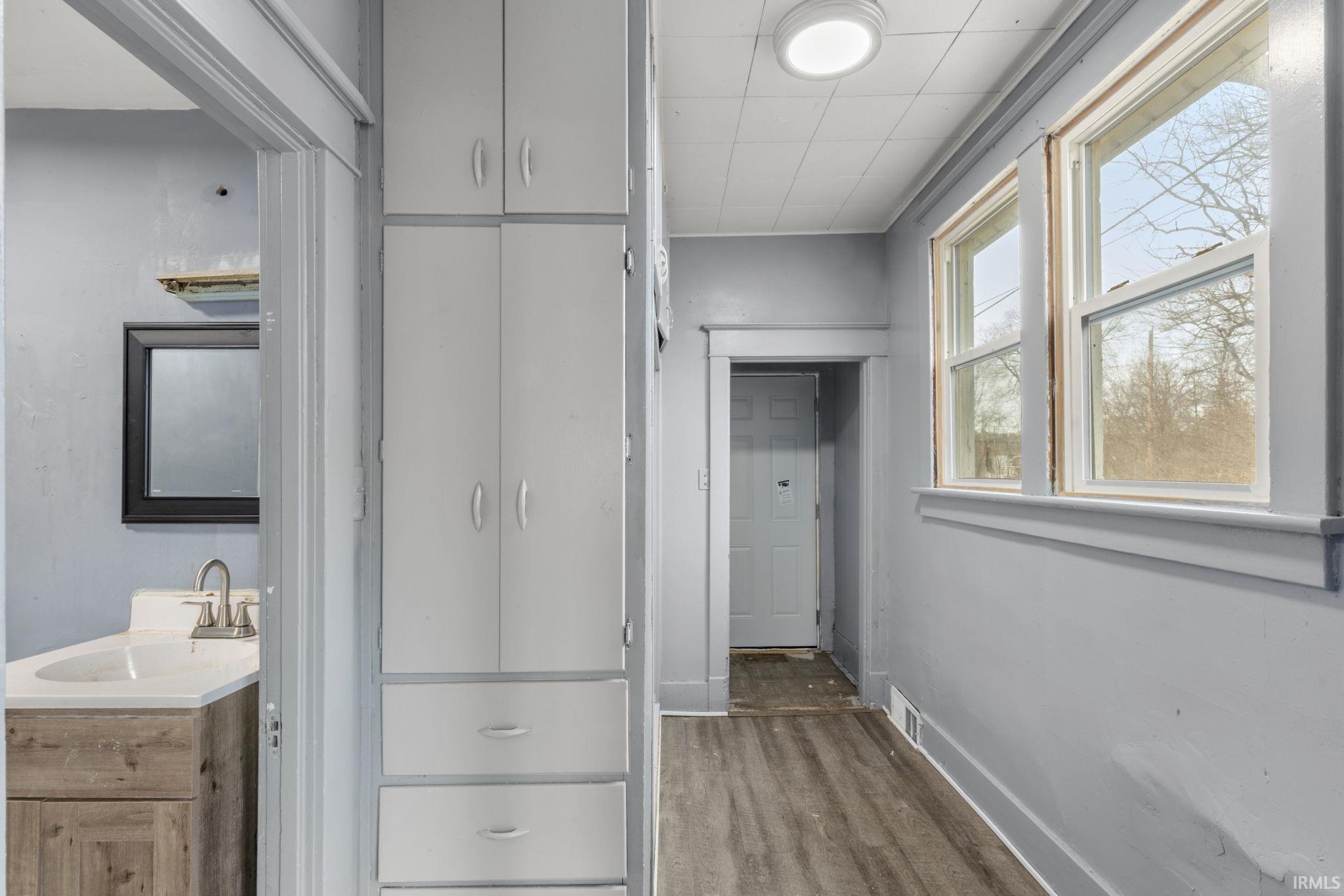 Hallway featuring baseboards and wood finished floors