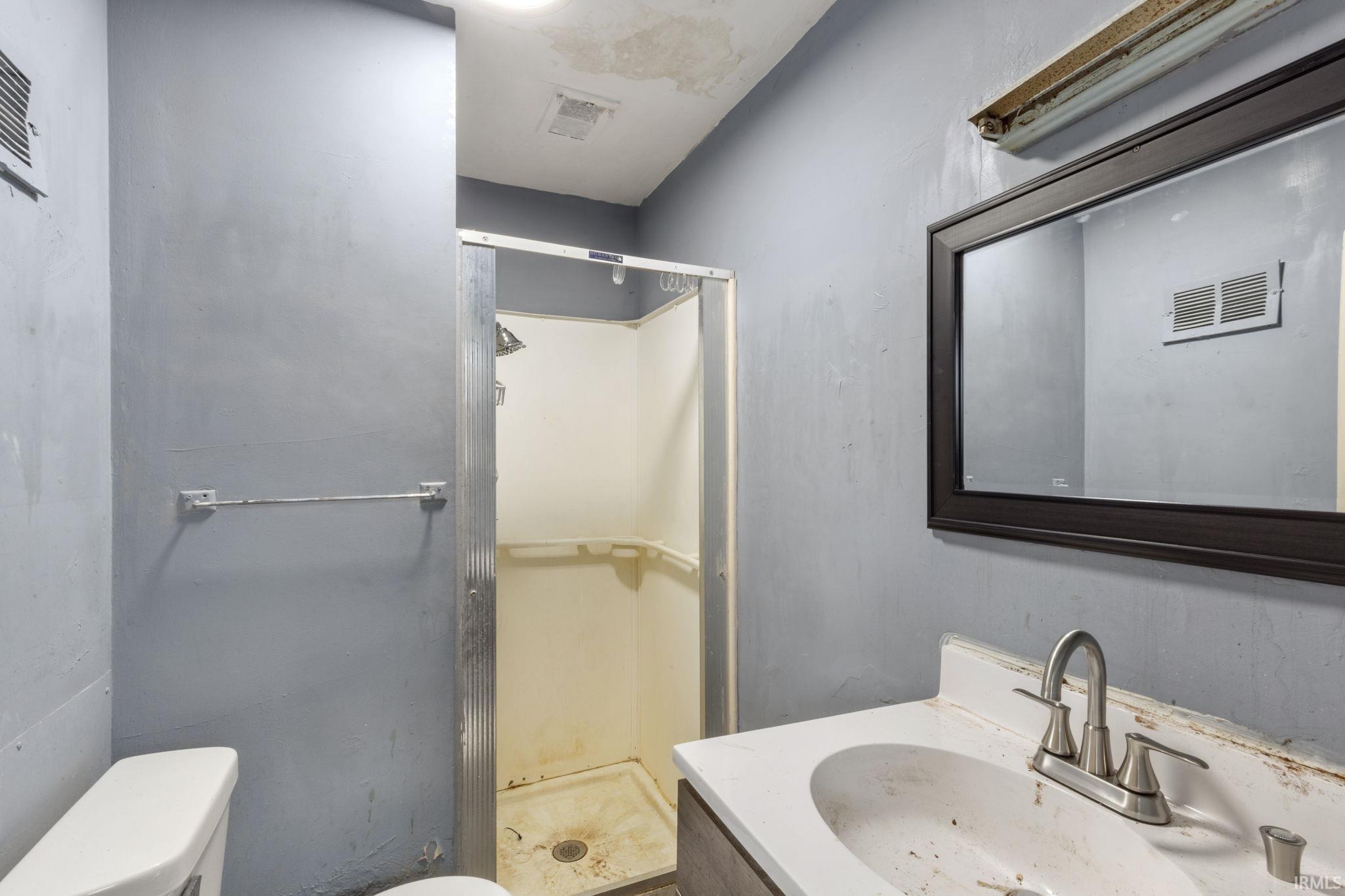 Full bath featuring vanity and a stall shower